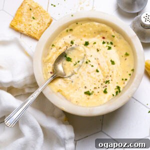Garlic Parmesan Sauce being poured, showing its creamy texture.