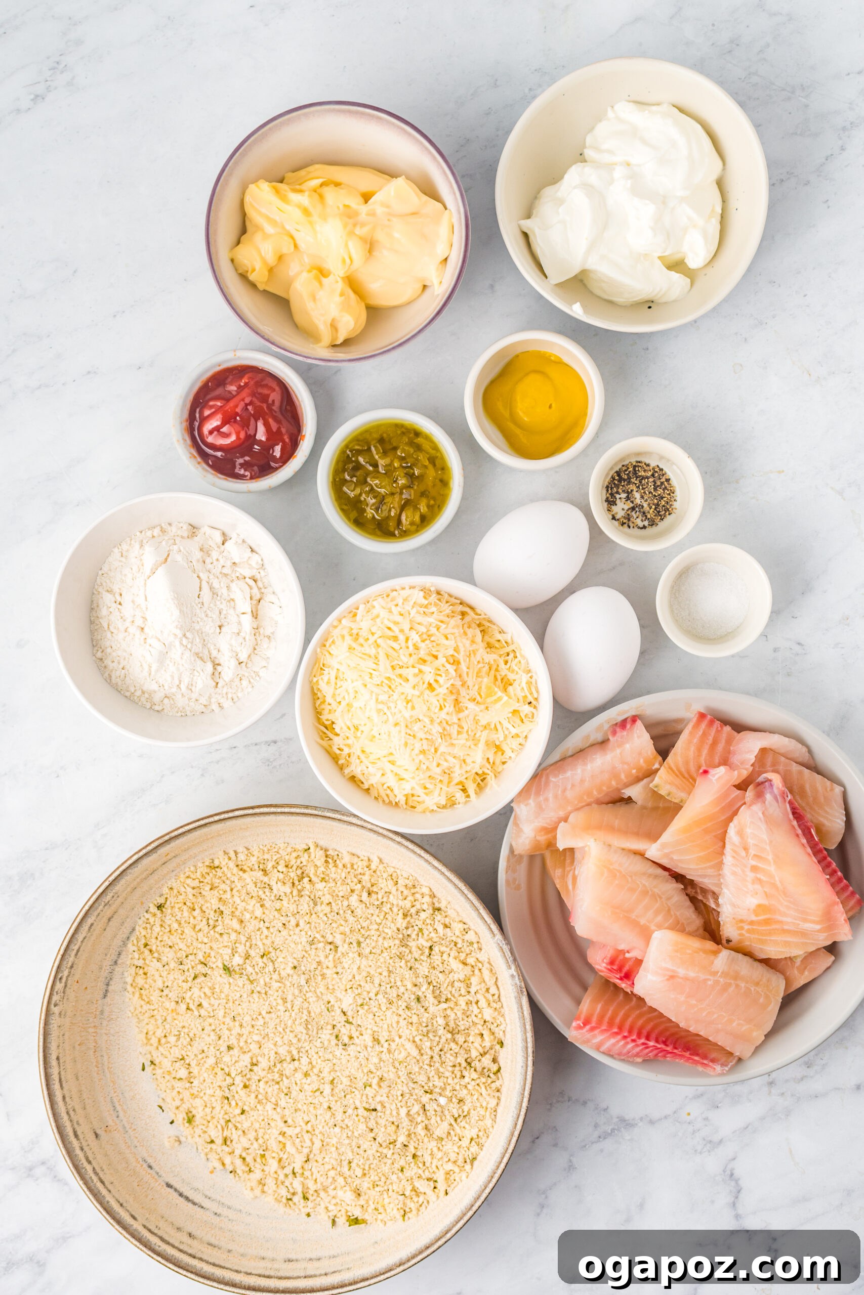 Ingredients for Baked Parmesan Fish Sticks laid out on a table.