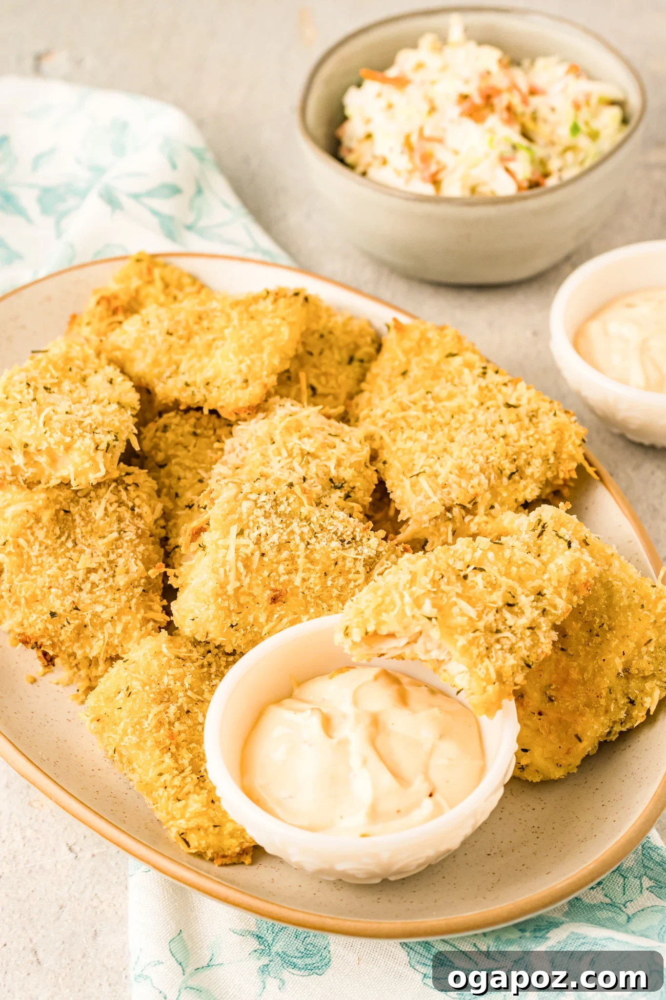 Baked Parmesan Fish Sticks served with a side of creamy dip.