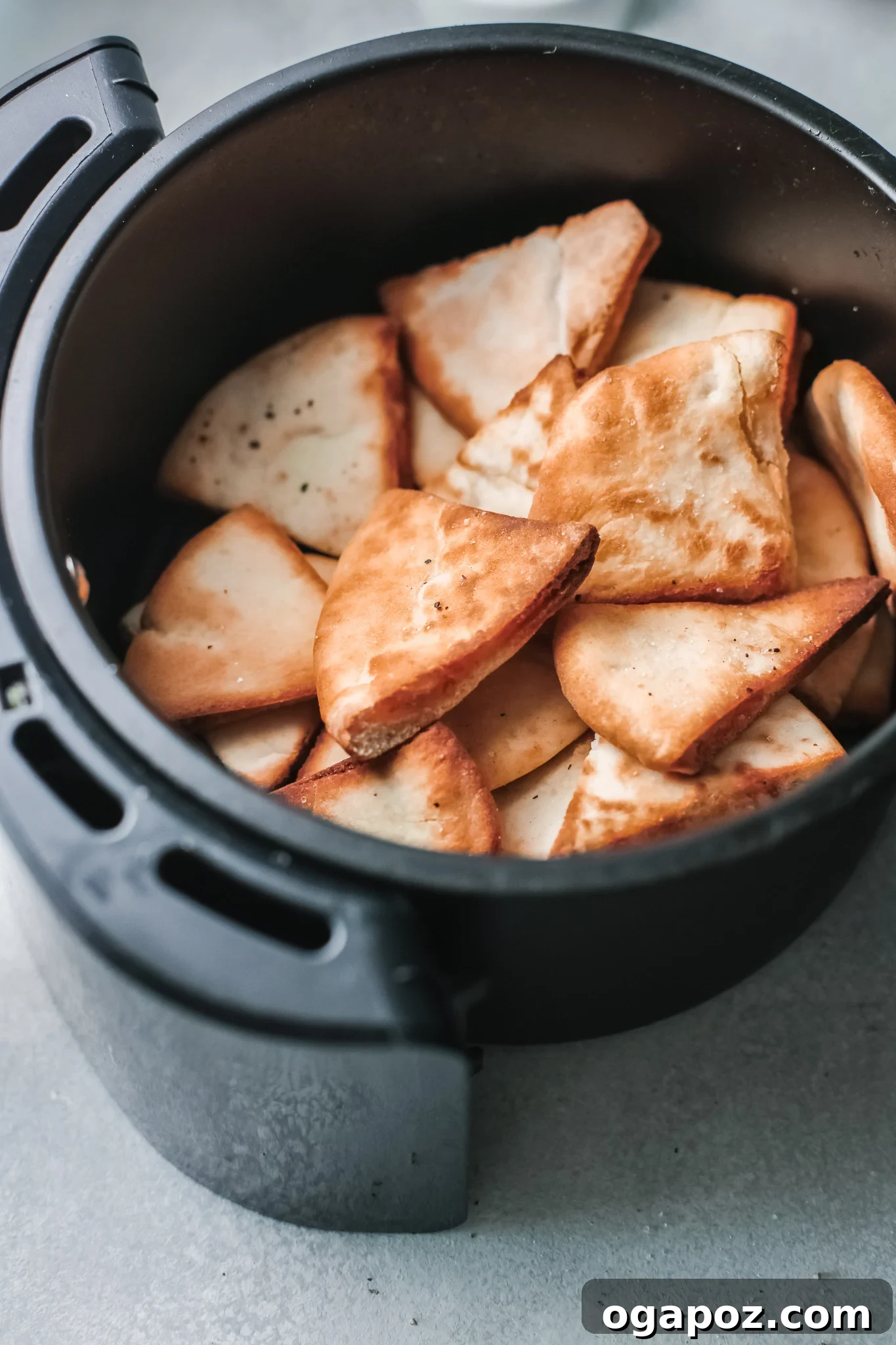 Crispy Air Fryer Pita Chips 7 Crispy Air Fryer Pita Chips after cooking, inside the air fryer basket.