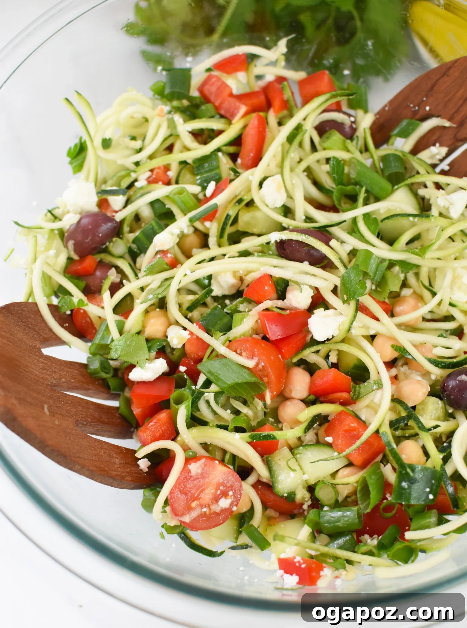 Vibrant Mediterranean Zucchini Pasta Salad 2 A beautifully arranged Mediterranean Zucchini Pasta Salad in a glass bowl, ready to be served.