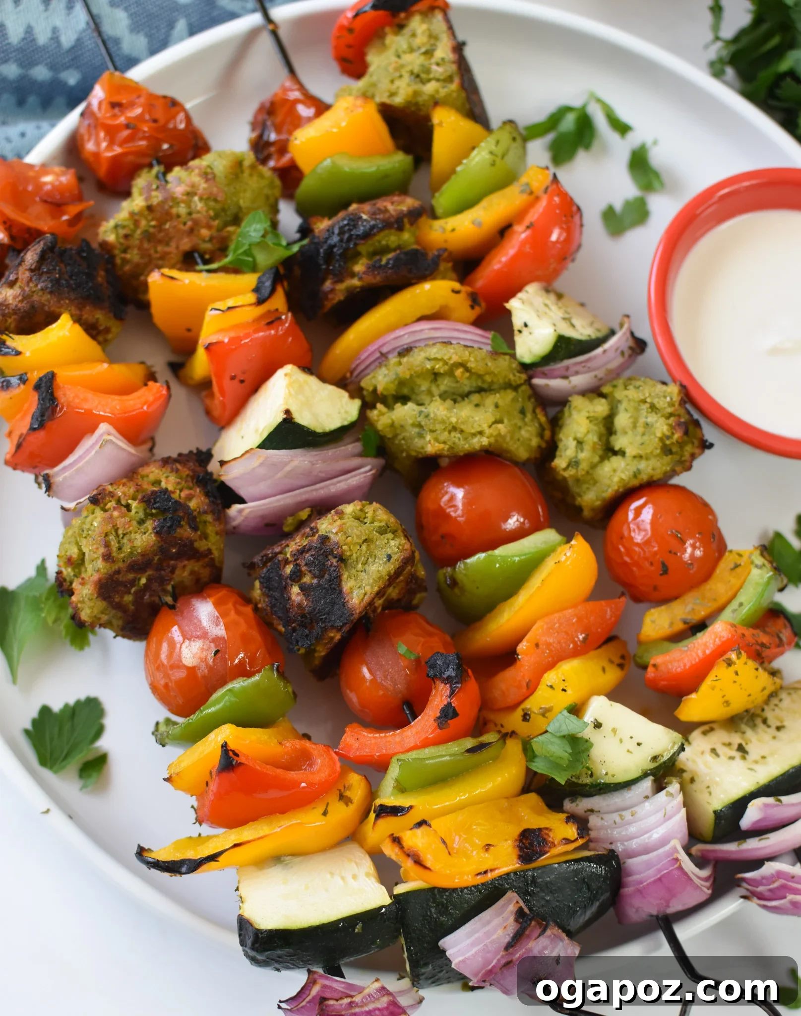 Mediterranean Falafel & Veggie Skewers 4 Close-up of freshly grilled Falafel Vegetable Kabobs on a white plate, showcasing the crispy falafel and perfectly charred, colorful vegetables.