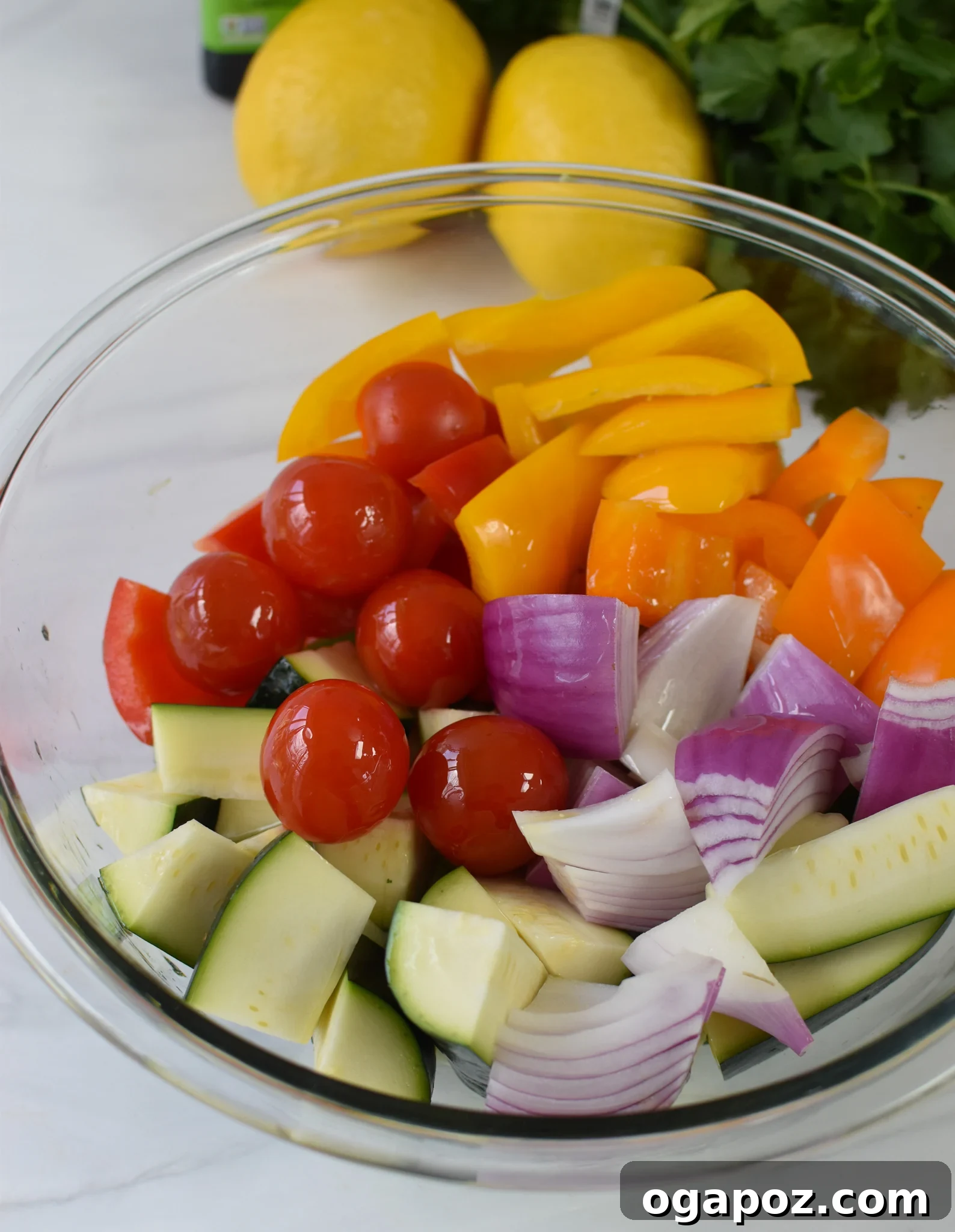 Mediterranean Falafel & Veggie Skewers 5 Assortment of chopped bell peppers, red onion, zucchini, and cherry tomatoes tossed with olive oil and spices in a large mixing bowl, ready for skewering.