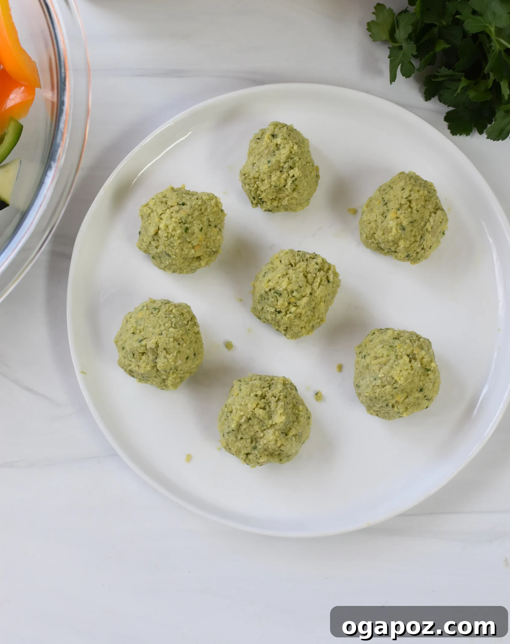 Mediterranean Falafel & Veggie Skewers 6 Prepared falafel balls, neatly rolled and arranged on a plate, awaiting assembly onto skewers for grilling.