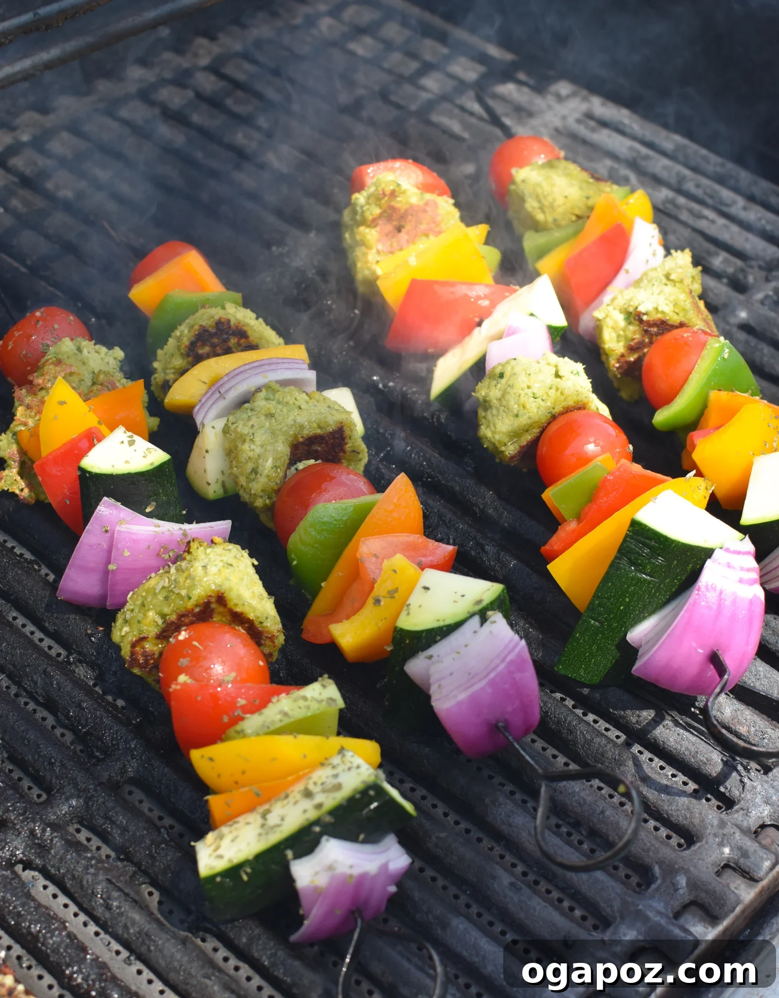 Mediterranean Falafel & Veggie Skewers 8 Falafel Vegetable Kabobs cooking on an outdoor grill, with visible char marks developing on the falafel and vegetables.