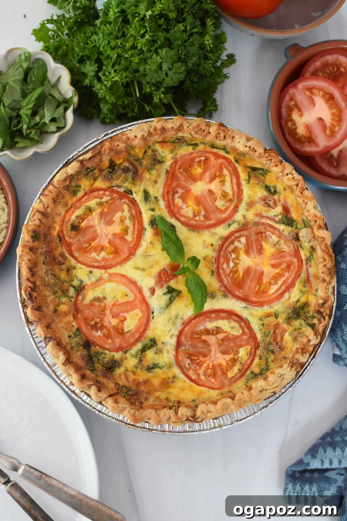 Italian Summer Quiche Lorraine 2 A beautifully baked Caprese Quiche Lorraine garnished with fresh basil, ready to be served for brunch or breakfast.