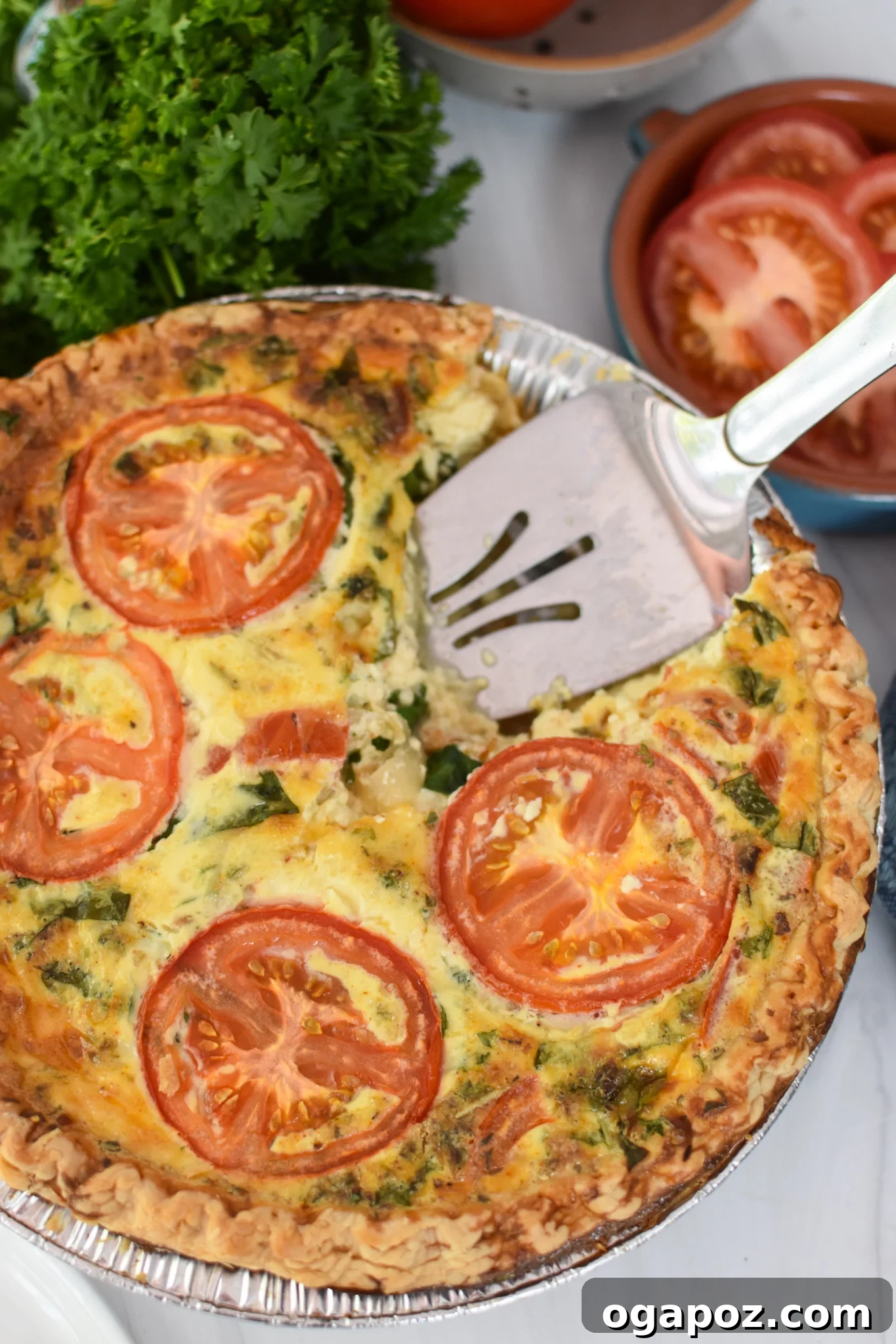 Italian Summer Quiche Lorraine 4 A slice of Caprese Quiche Lorraine being served with a pie server.