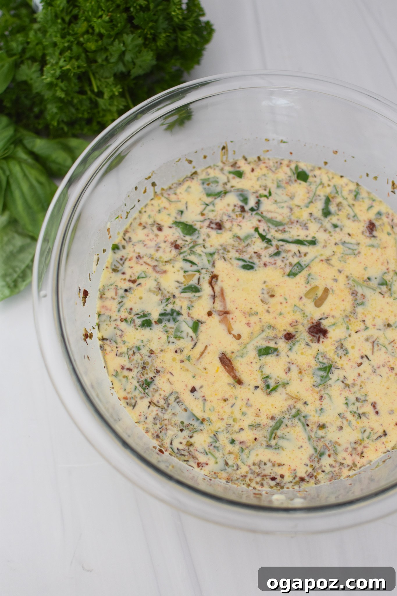 Italian Summer Quiche Lorraine 6 A creamy egg custard mixture with spices in a large mixing bowl.