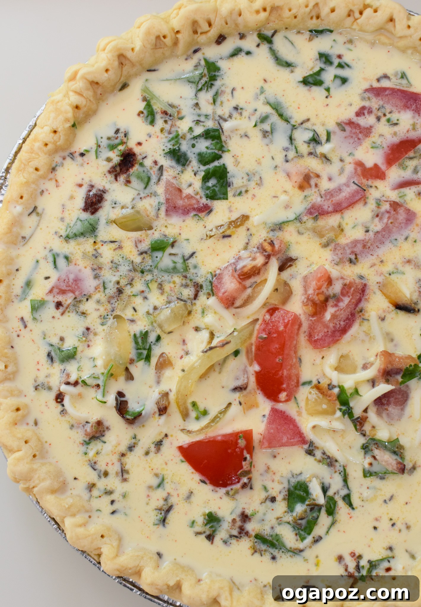 Italian Summer Quiche Lorraine 8 The Caprese Quiche Lorraine filling poured into the pre-baked pie crust, topped with shredded mozzarella.