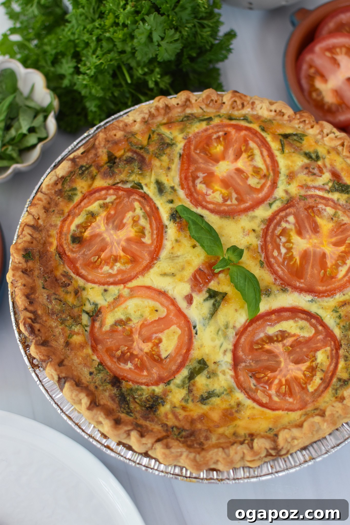Italian Summer Quiche Lorraine 10 Caprese Quiche Lorraine garnished with fresh basil leaves.