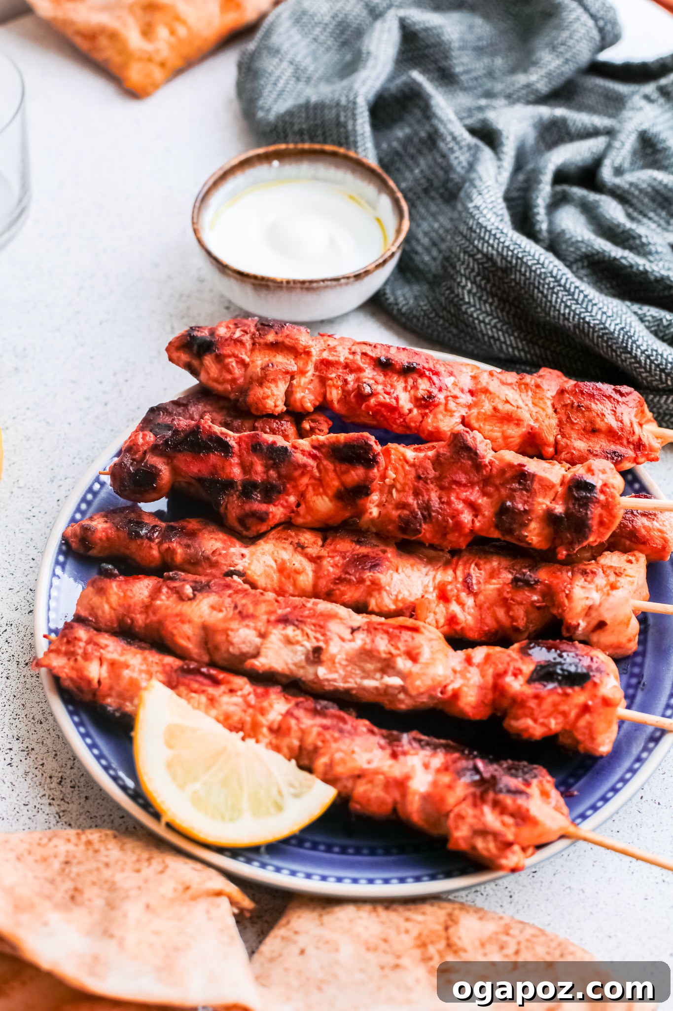 Marinated Lebanese Chicken Skewers 7 Lebanese Chicken Kebabs on a blue platter.