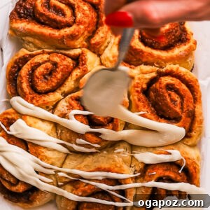 Biscuit Cinnamon Rolls drizzled with cream cheese icing.