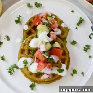 Top-down view of golden Falafel Waffles with toppings.