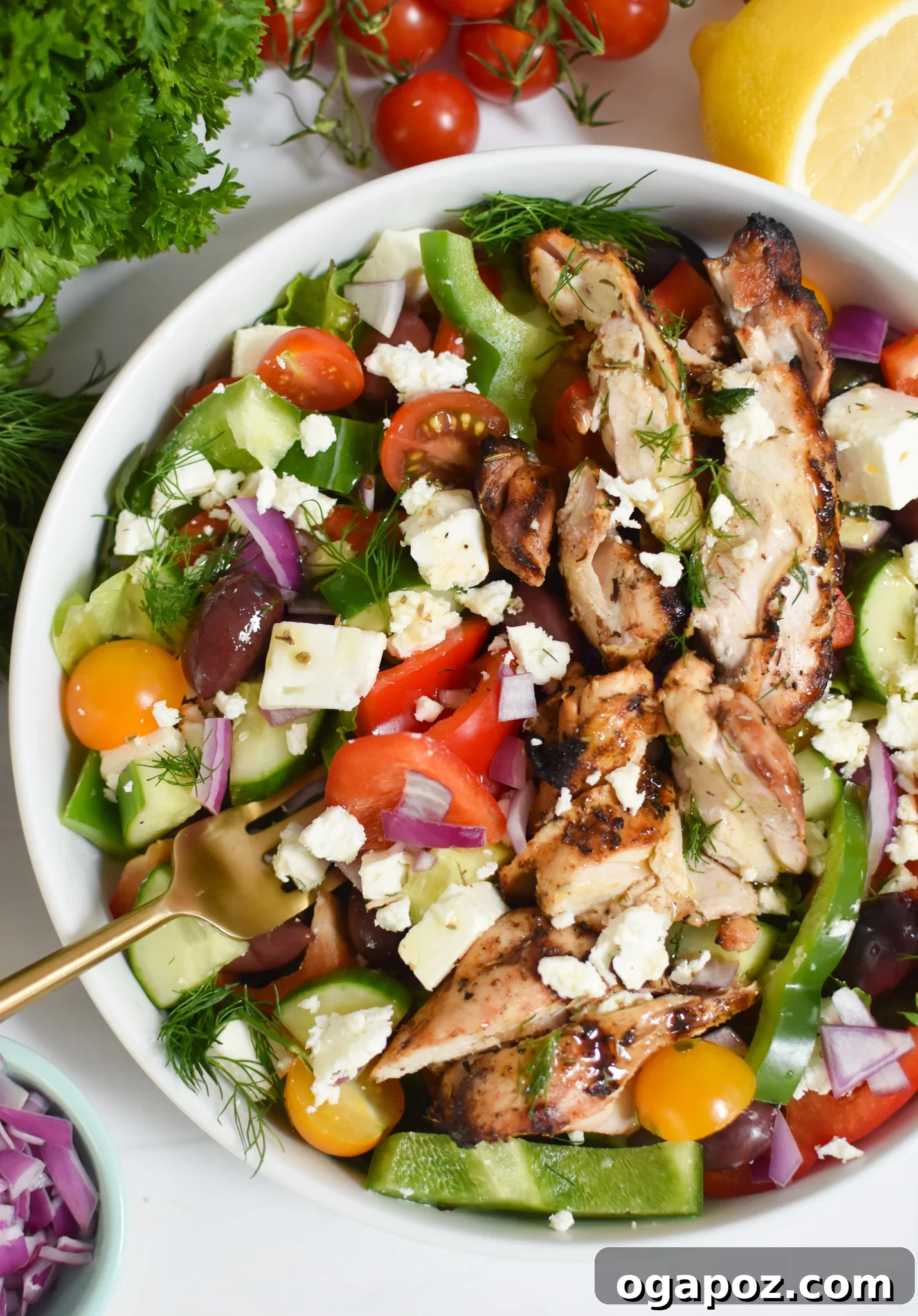 A vibrant Grilled Chicken Greek Salad served in a pristine white bowl, showcasing fresh ingredients.