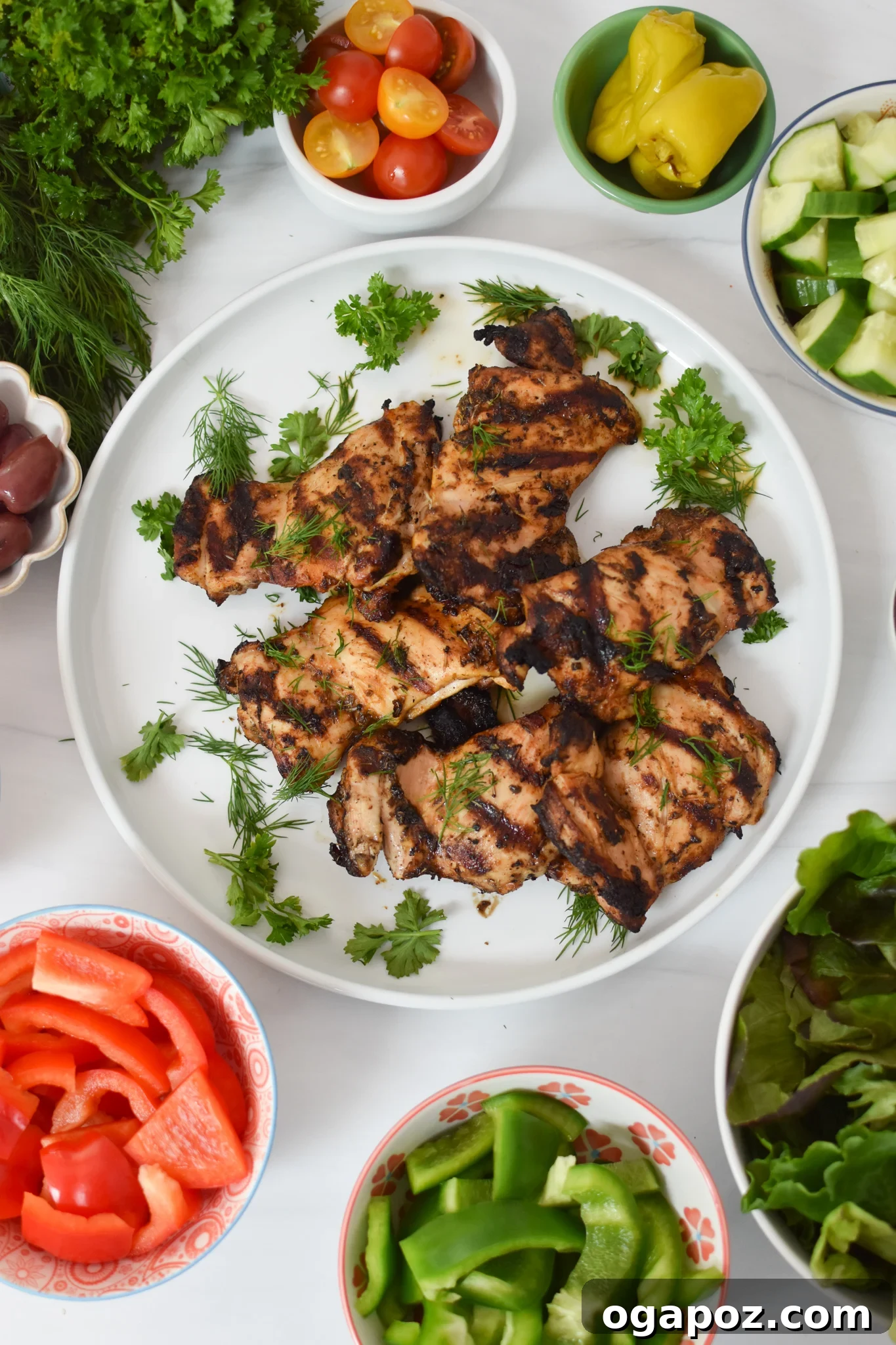 Perfectly grilled Greek chicken thighs resting on a plate, ready to be sliced for the salad.