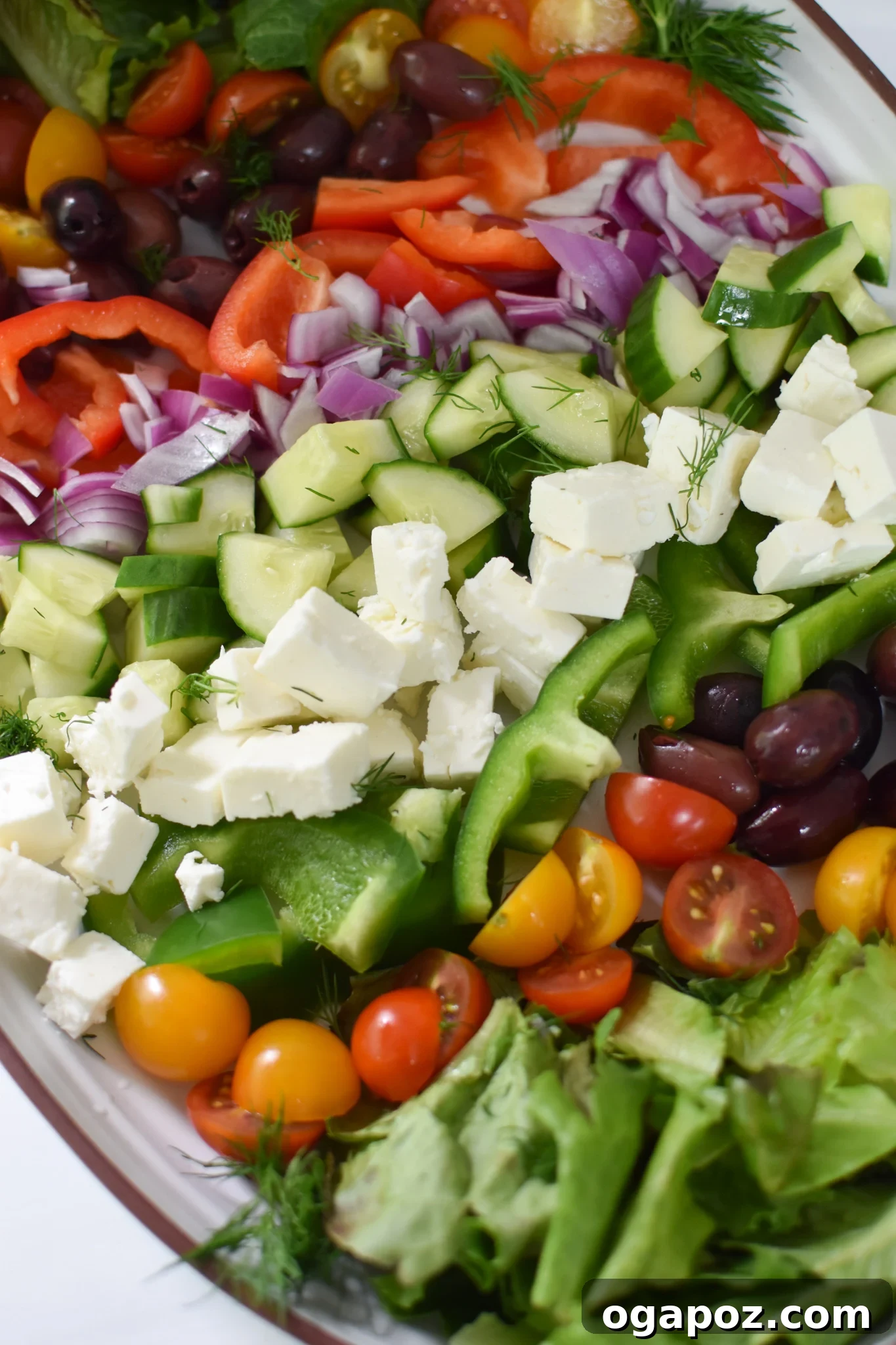 A stunning Grilled Chicken Greek Salad artfully arranged on a large serving platter.