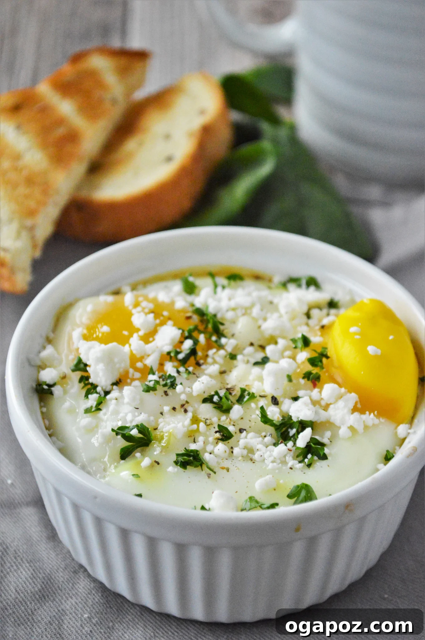 Rustic Greek Egg Bake 2 A perfectly cooked Greek Baked Egg in a white ramekin, ready to be enjoyed.