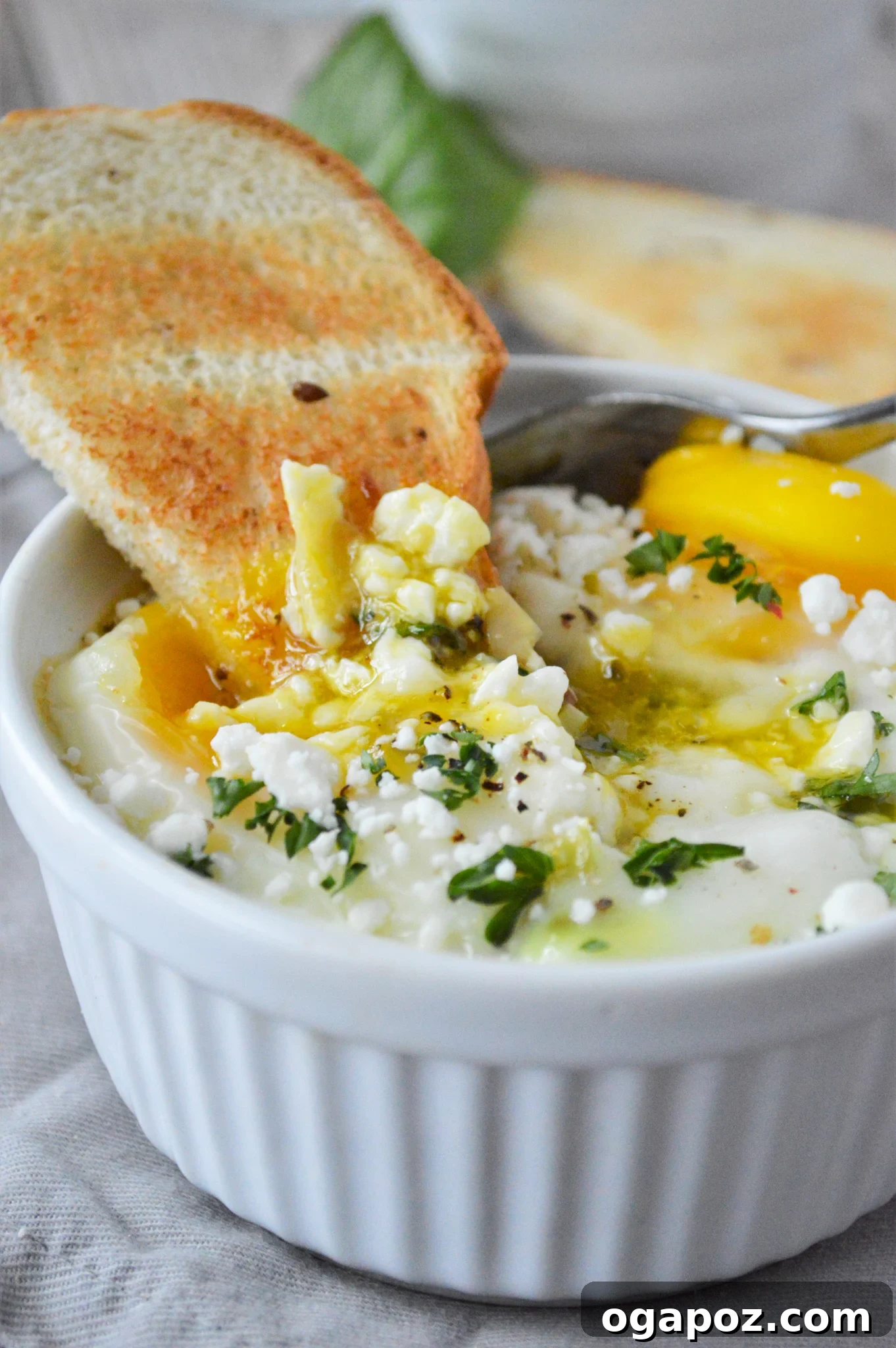 Rustic Greek Egg Bake 4 Greek Baked Eggs served with a slice of golden toast, perfect for dipping.