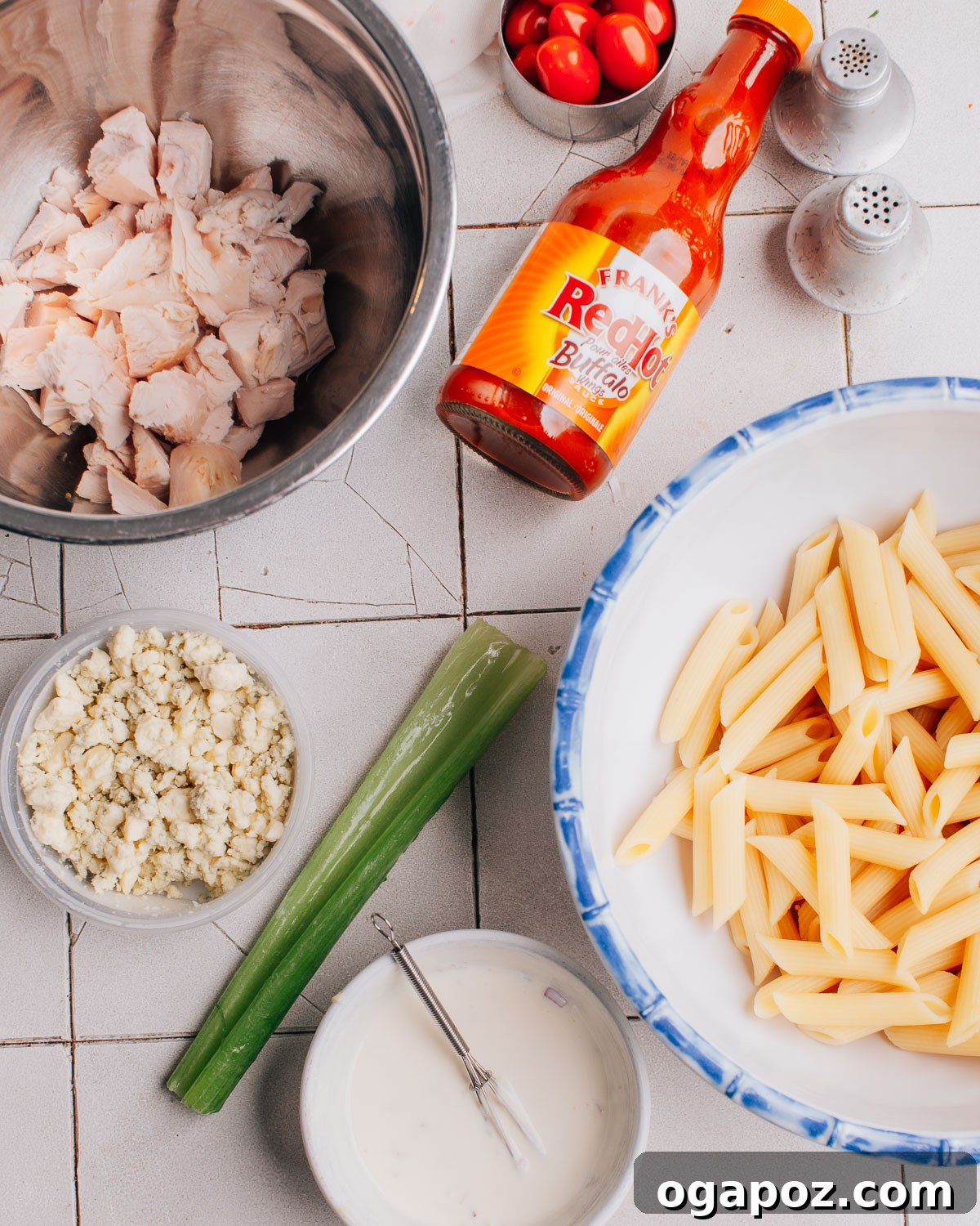 Ingredients for making Buffalo Chicken Pasta Salad recipe arranged on a counter.