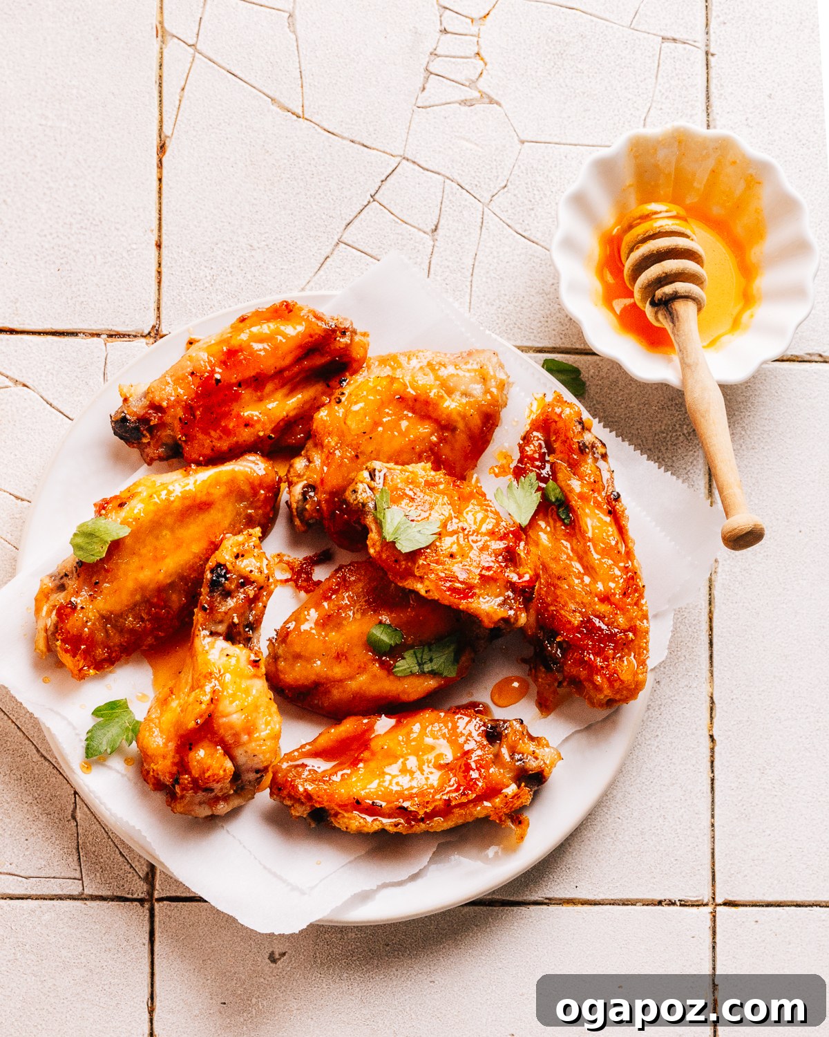 Hot Honey Glazed Crispy Wings 2 Hot Honey Wings, crispy and coated in a sticky glaze on a serving platter