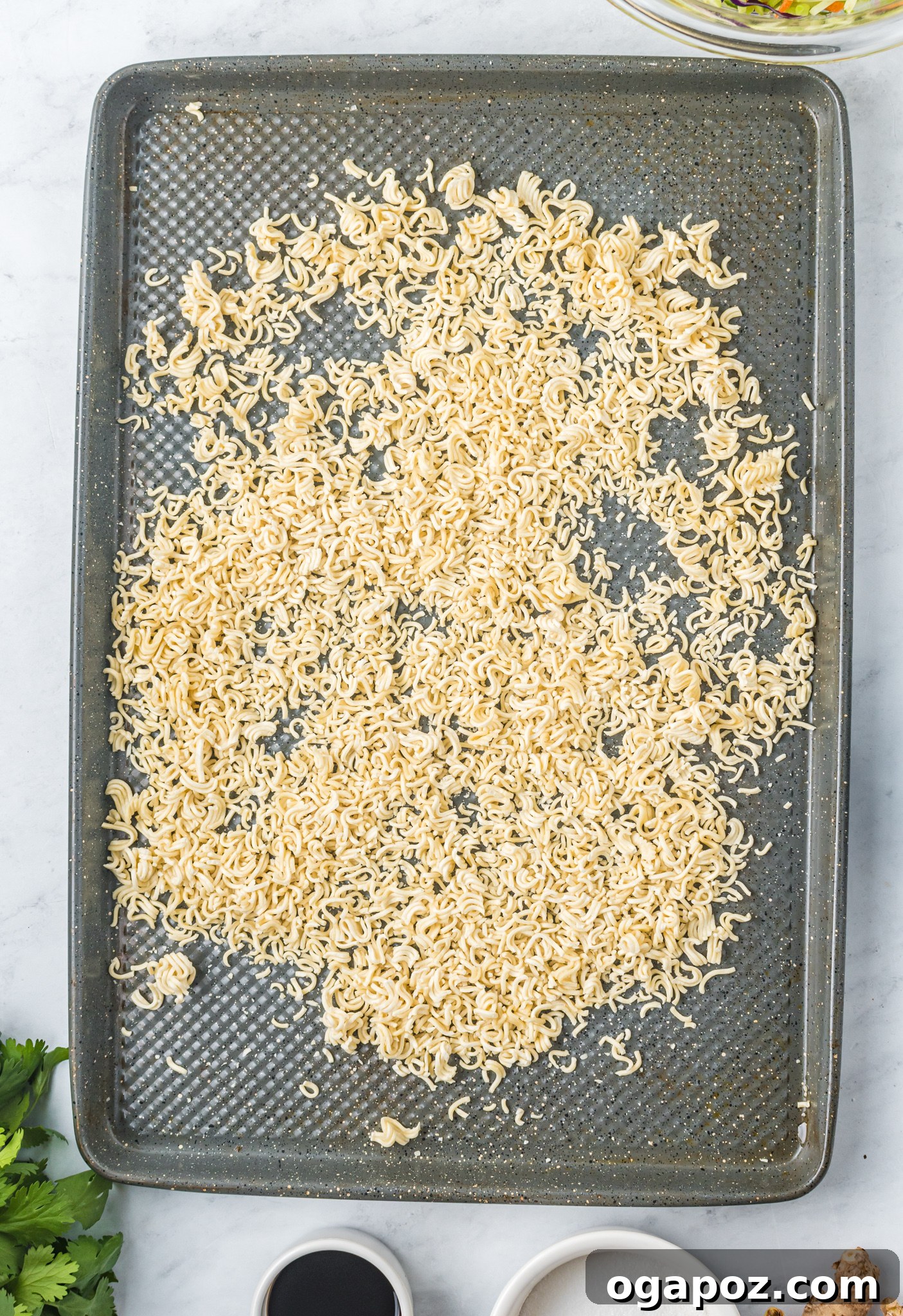 The Ultimate Broccoli Slaw 6 Toasted ramen noodles and sliced almonds on a baking sheet, golden and crisp, ready for the salad.