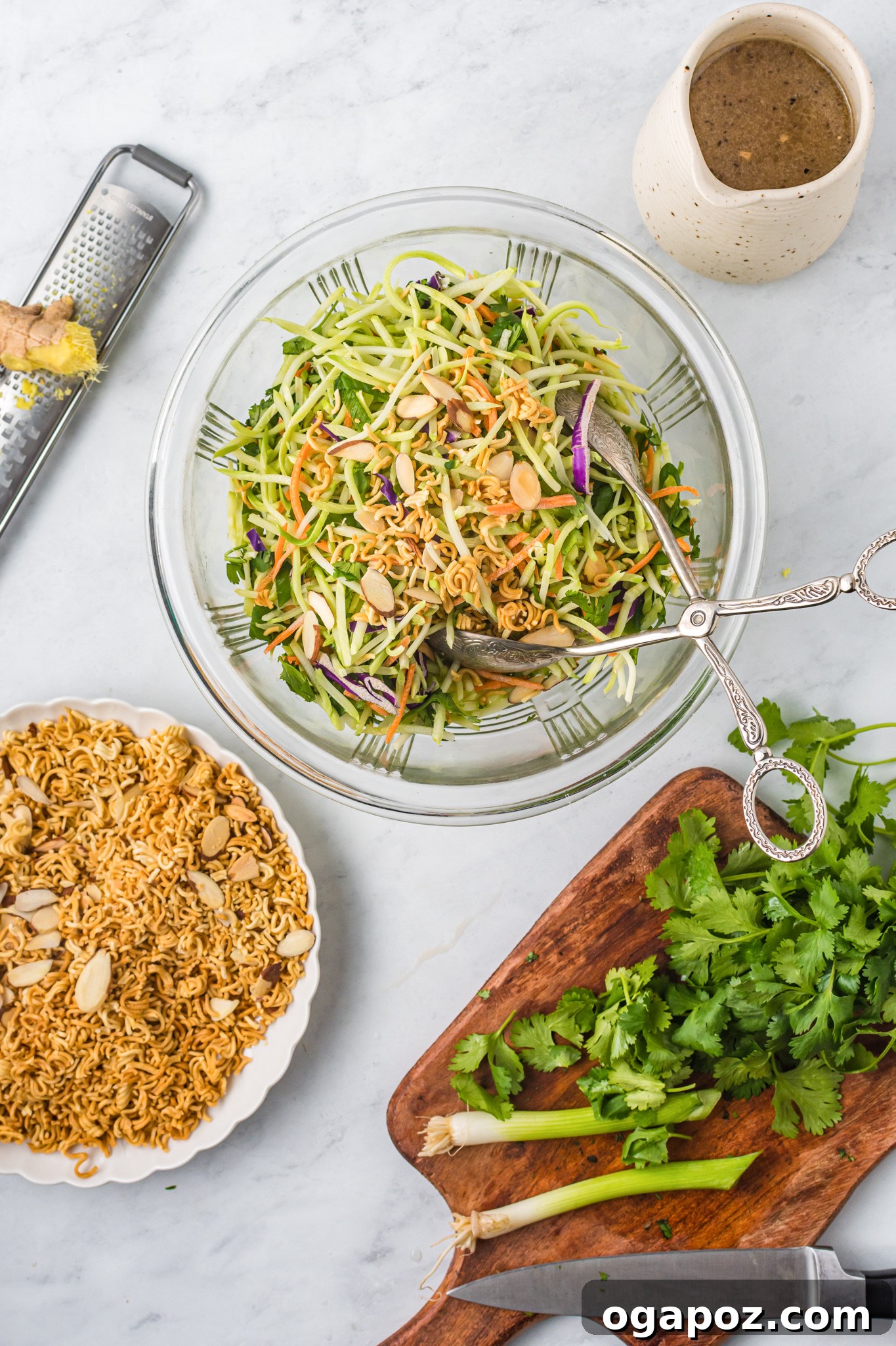 The Ultimate Broccoli Slaw 7 Fresh broccoli slaw, cilantro, and green onions being prepared in a large mixing bowl, showing the vibrant colors of the vegetables.