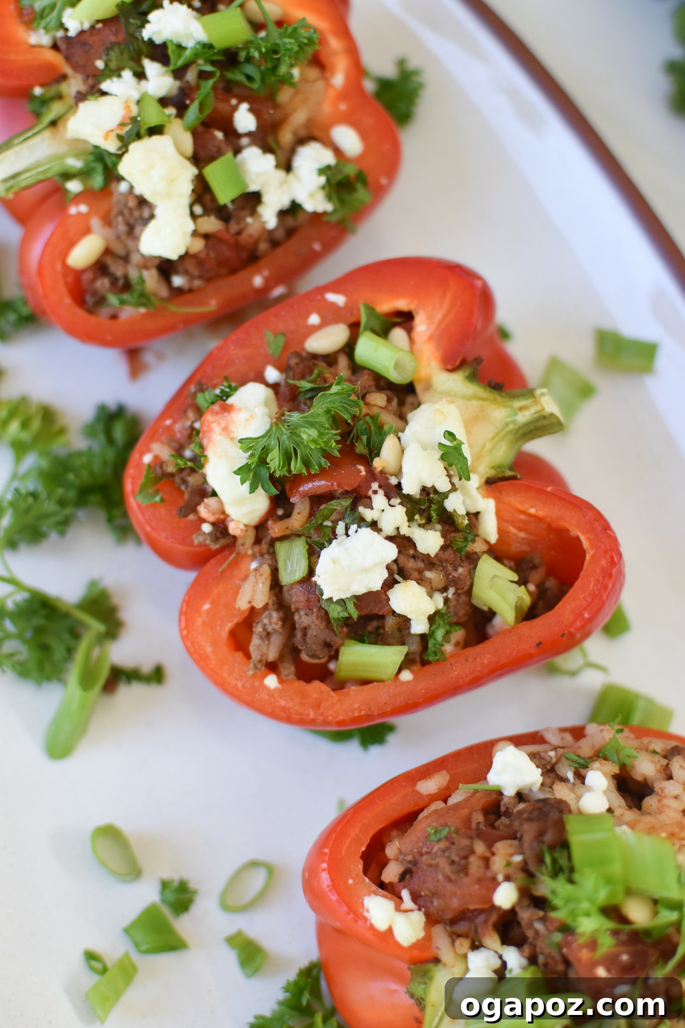 Mediterranean Beef Filled Bell Peppers 2 Mediterranean Ground Beef Stuffed Peppers on a white platter.