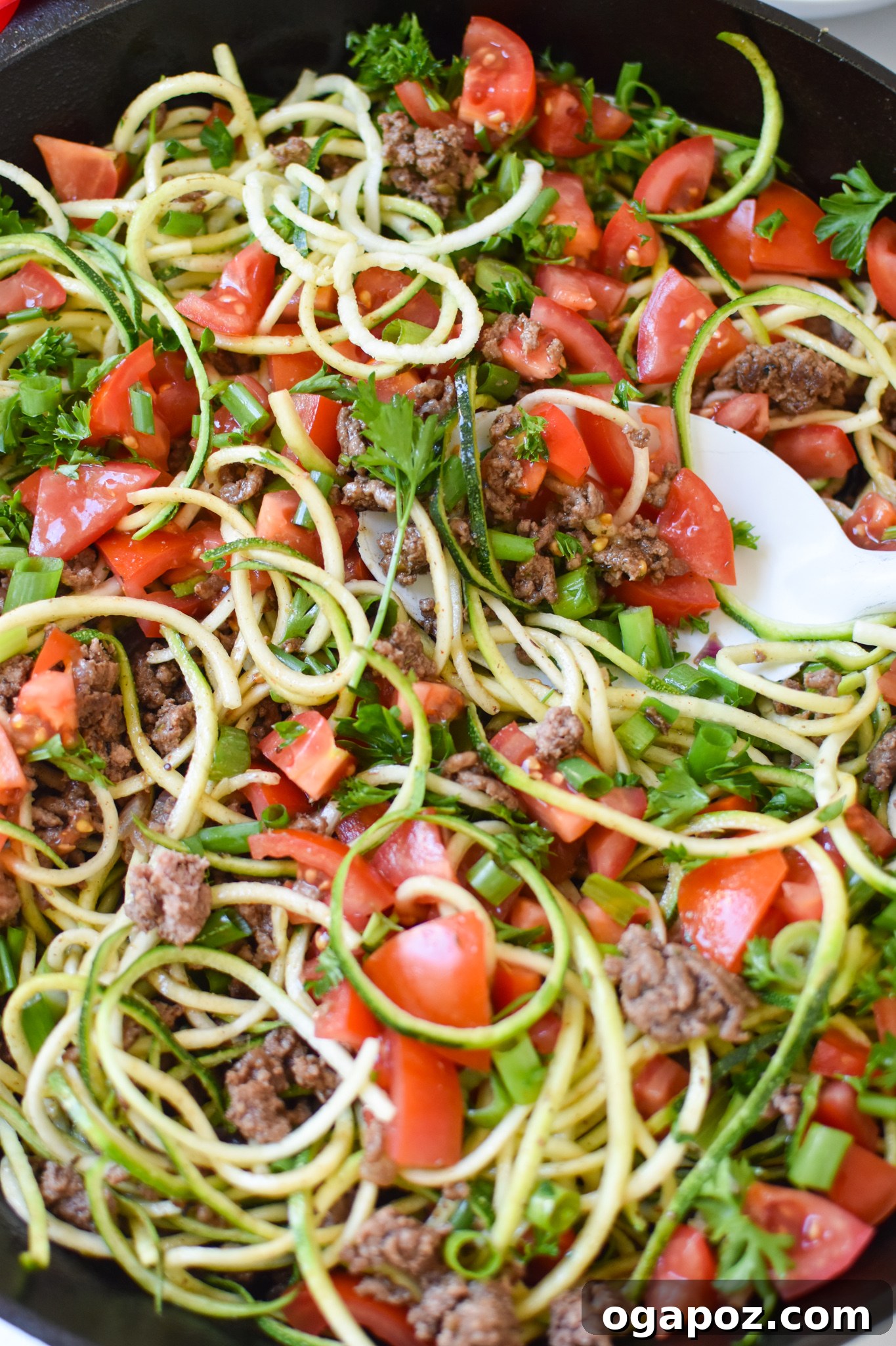 Vibrant Mediterranean Beef and Zucchini Skillet 3 Mediterranean Ground Beef Zucchini Skillet served with a white spoon.