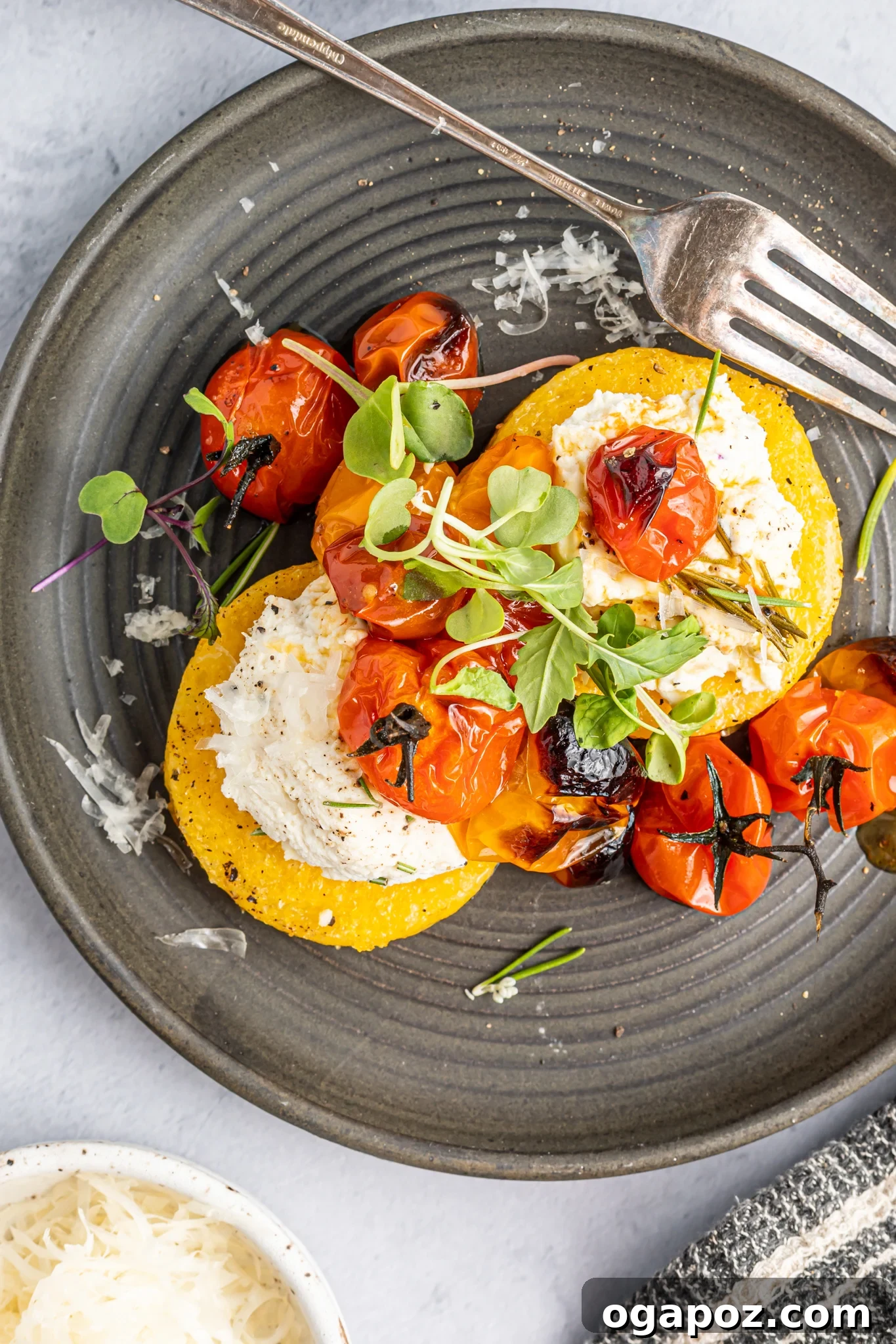 Golden Polenta Towers 4 Crispy Polenta Stacks with perfectly roasted cherry tomatoes nestled between layers.