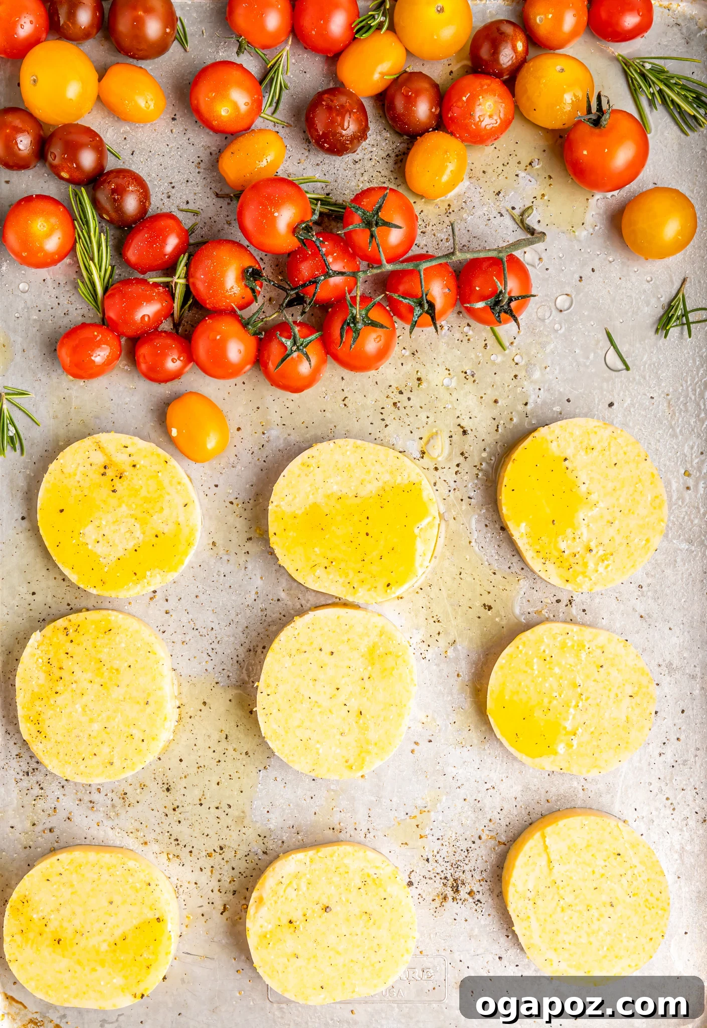 Golden Polenta Towers 7 Crispy polenta rounds and roasted cherry tomatoes on a baking sheet, fresh from the oven.