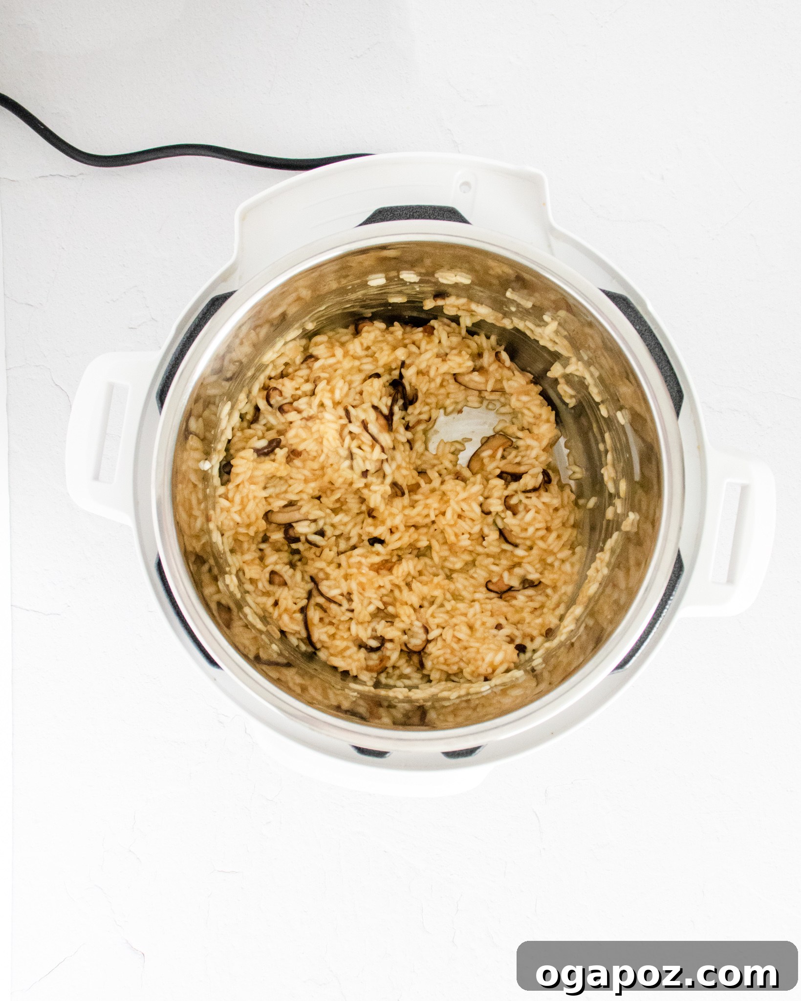 Creamy Instant Pot Mushroom Risotto 7 Steam being released from an Instant Pot after cooking mushroom risotto.