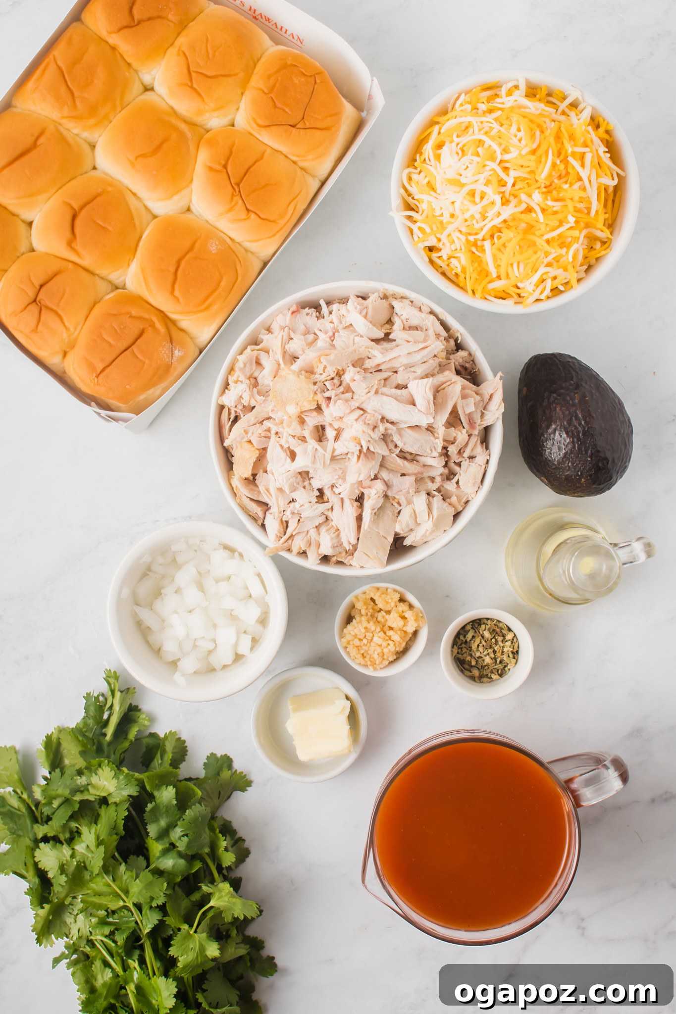 Pull-Apart Chicken Enchilada Sliders 3 All the fresh ingredients laid out for making Chicken Enchilada Sliders: rolls, shredded chicken, cheese, enchilada sauce, onion, garlic, and cilantro.
