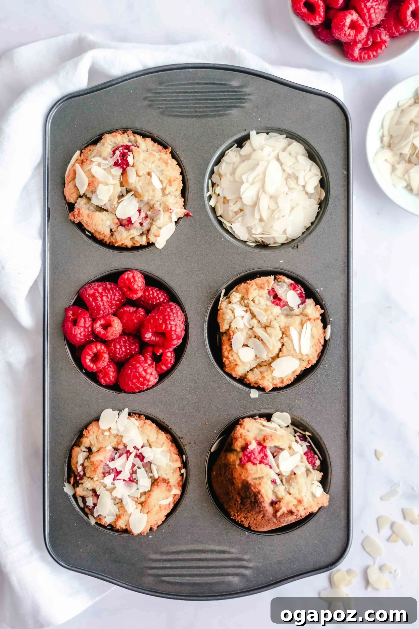 Delightful Keto Raspberry Muffins 4 Keto Raspberry Muffins baking in a muffin tin.