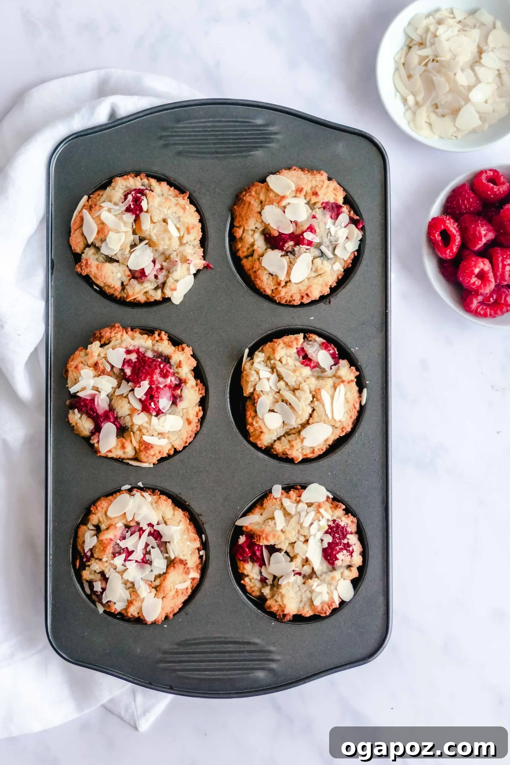 Delightful Keto Raspberry Muffins 5 Keto Raspberry Muffins with fresh raspberries on top, showing their texture.