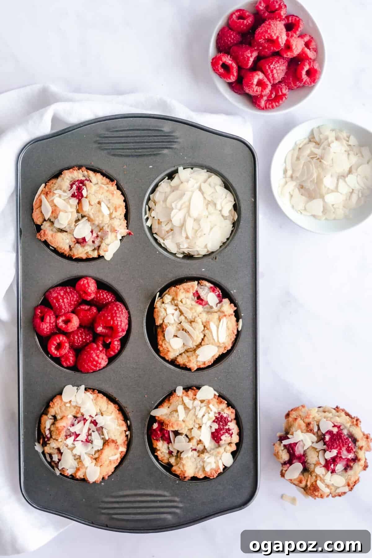 Delightful Keto Raspberry Muffins 6 Keto Raspberry Muffins cooling in a muffin tin.