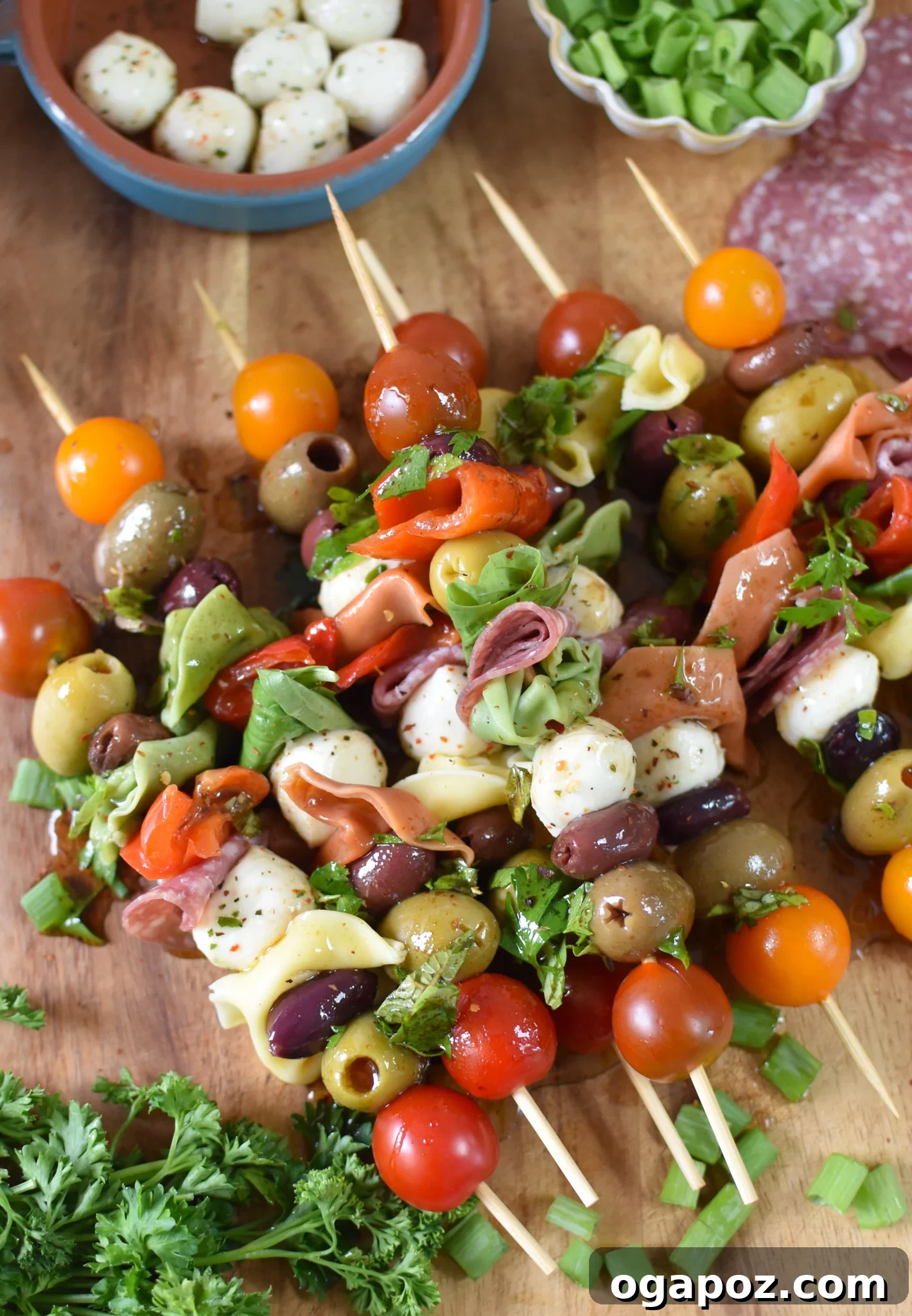 Flavorful Skewer Bites 3 Antipasto Skewers artfully arranged on a rustic cutting board, highlighting the fresh ingredients.