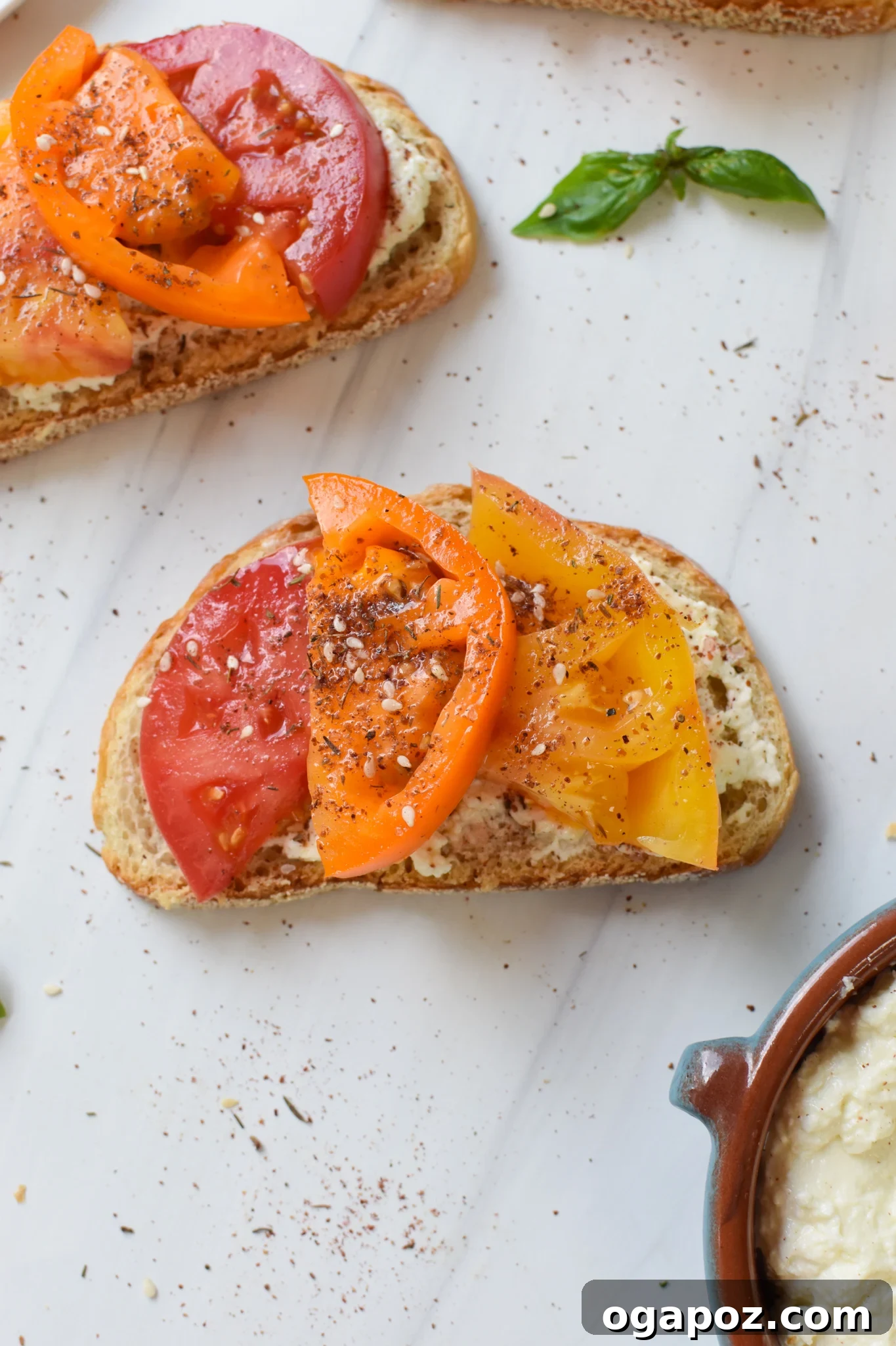 Heirloom Tomato Toast with Fluffy Feta 2 Tomato Toast with Whipped Feta with fresh basil.