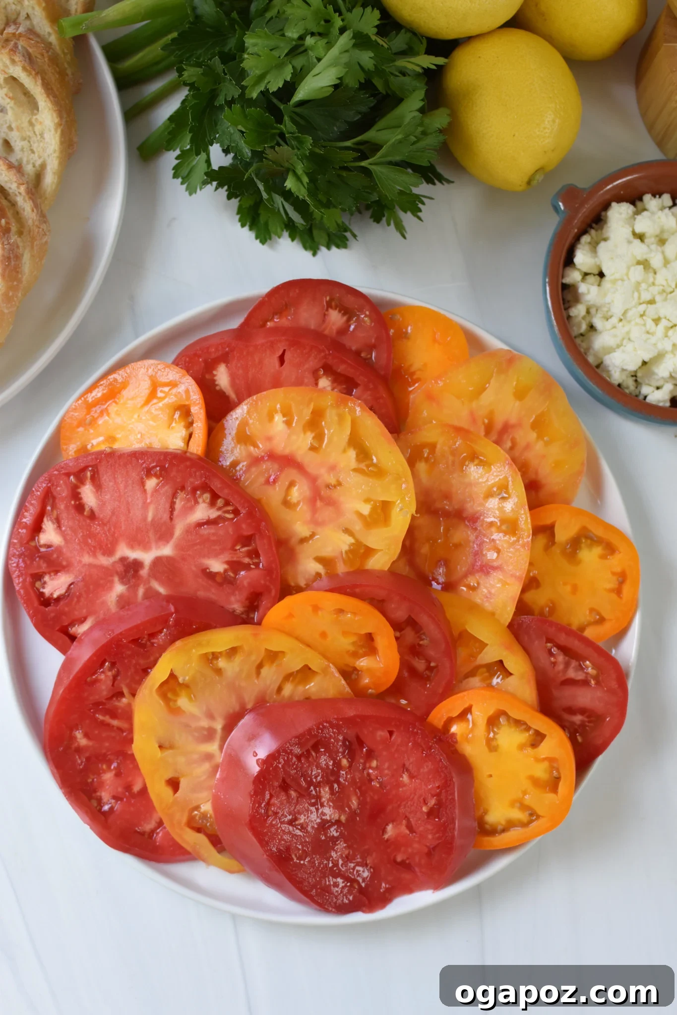 Heirloom Tomato Toast with Fluffy Feta 4 Tomato Toast with Whipped Feta heirloom tomatoes on a white plate.