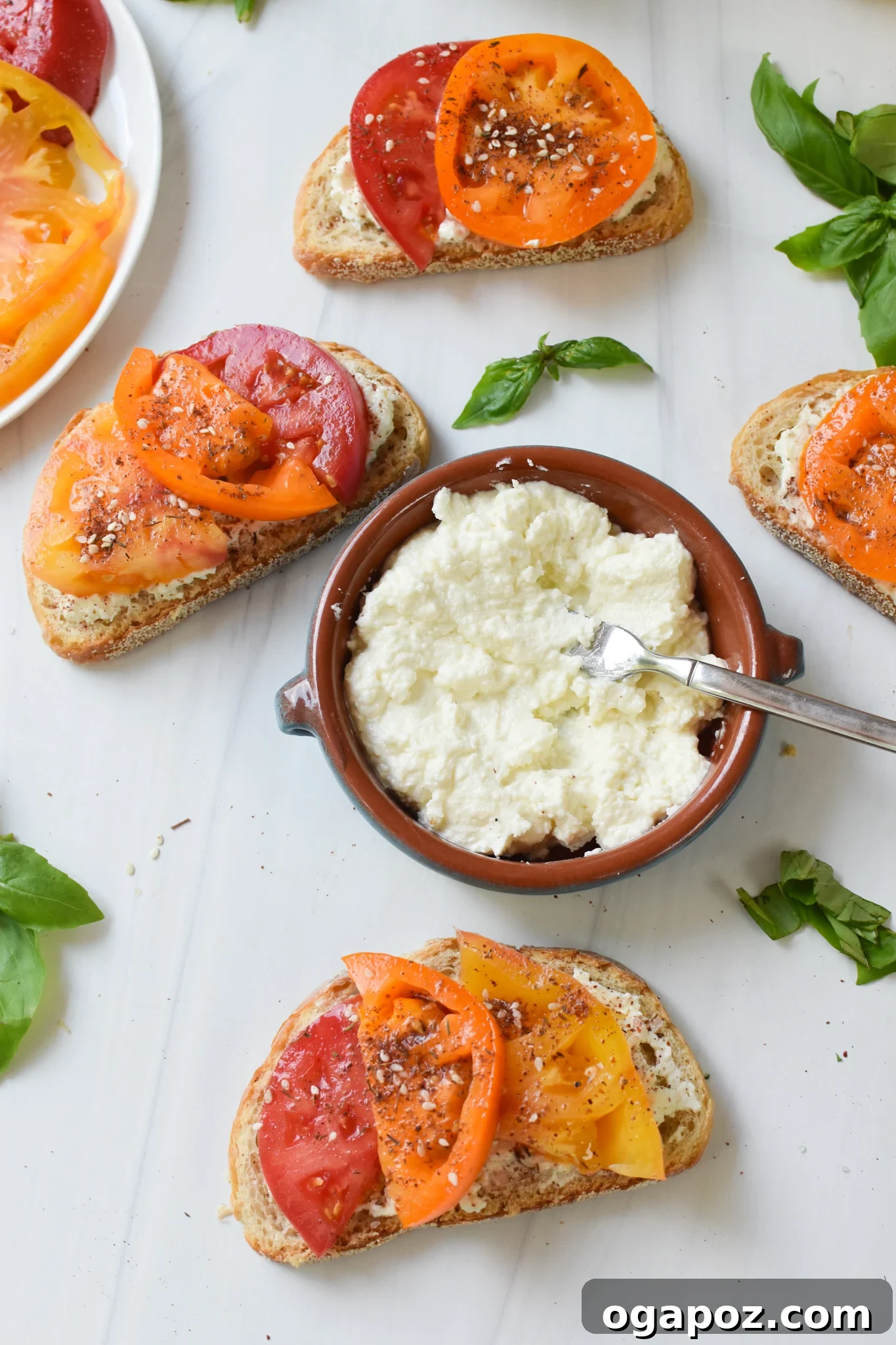 Heirloom Tomato Toast with Fluffy Feta 8 Tomato Toast with Whipped Feta with feta in the middle.