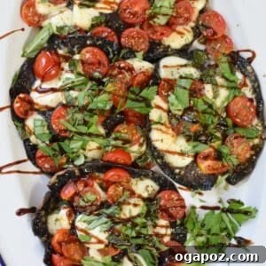 Caprese Stuffed Portobello Mushrooms on a white plate with balsamic drizzle