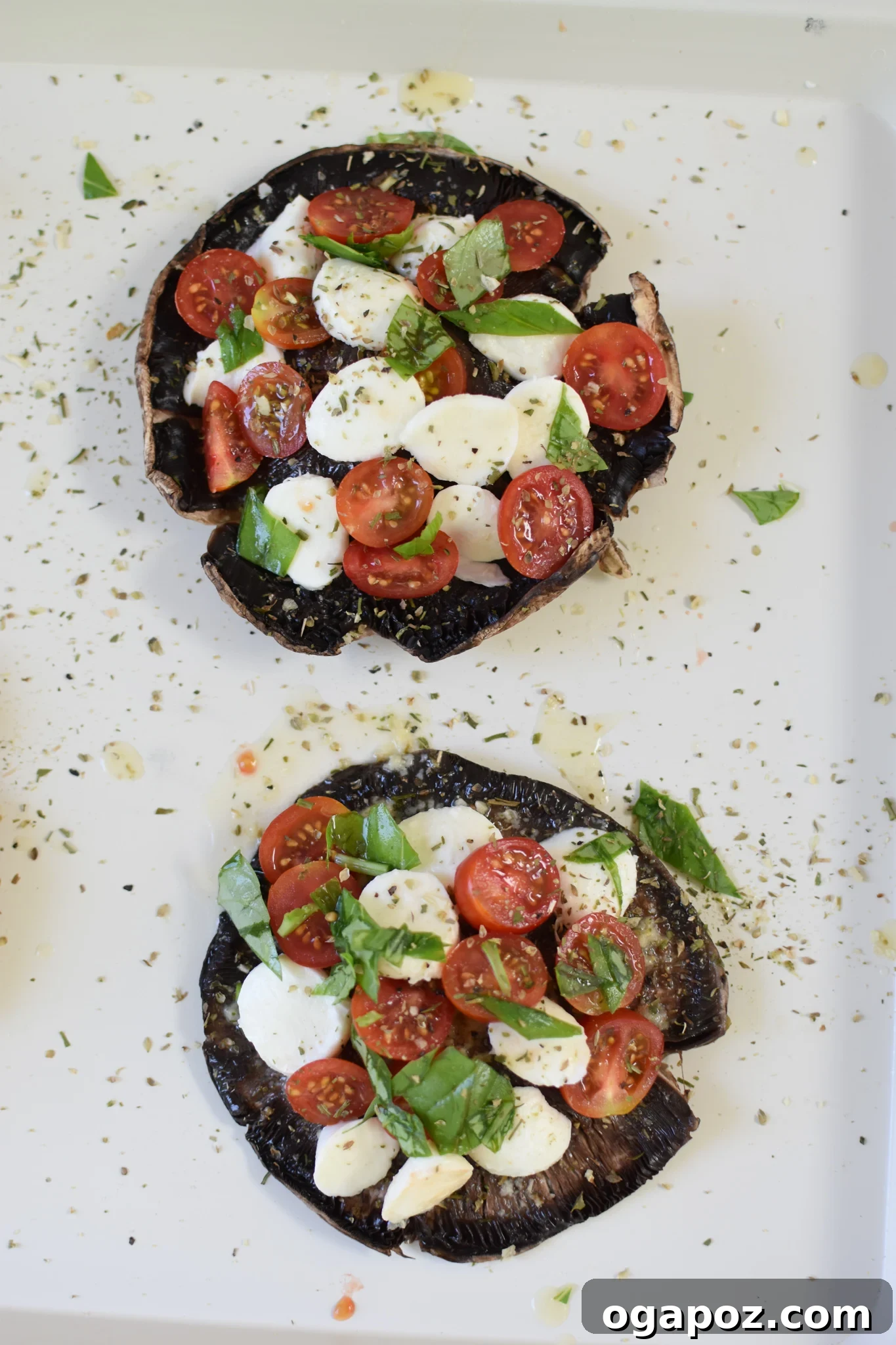 Roasted Caprese Portobellos 7 Freshly prepped Caprese Stuffed Portobello Mushrooms arranged on a baking sheet before baking.
