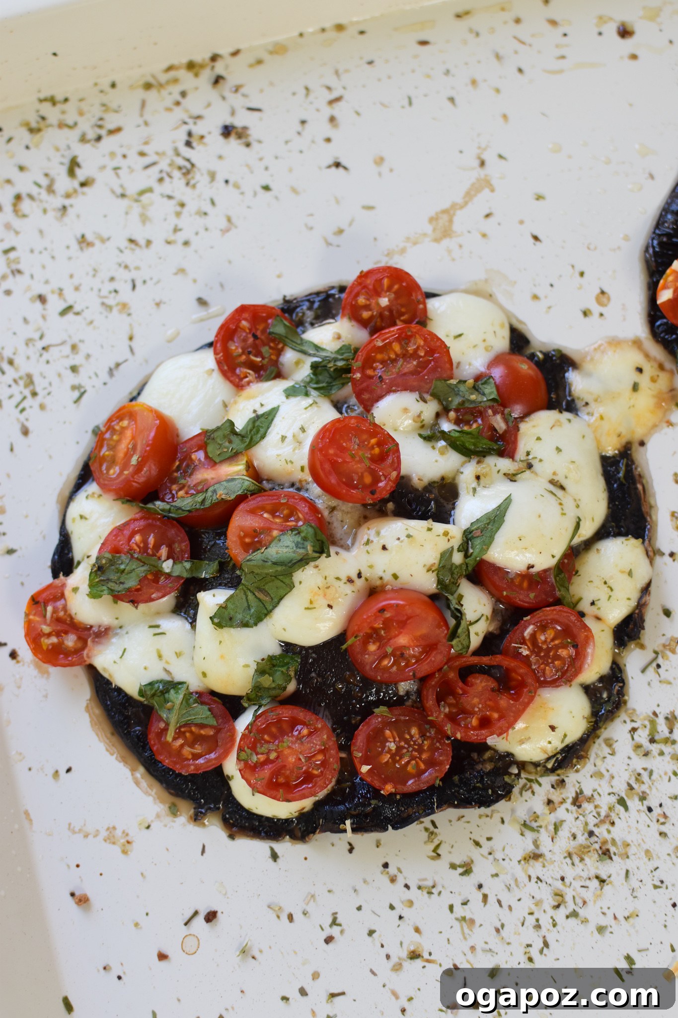 Roasted Caprese Portobellos 8 Caprese Stuffed Portobello Mushrooms baked to golden perfection on a baking sheet.