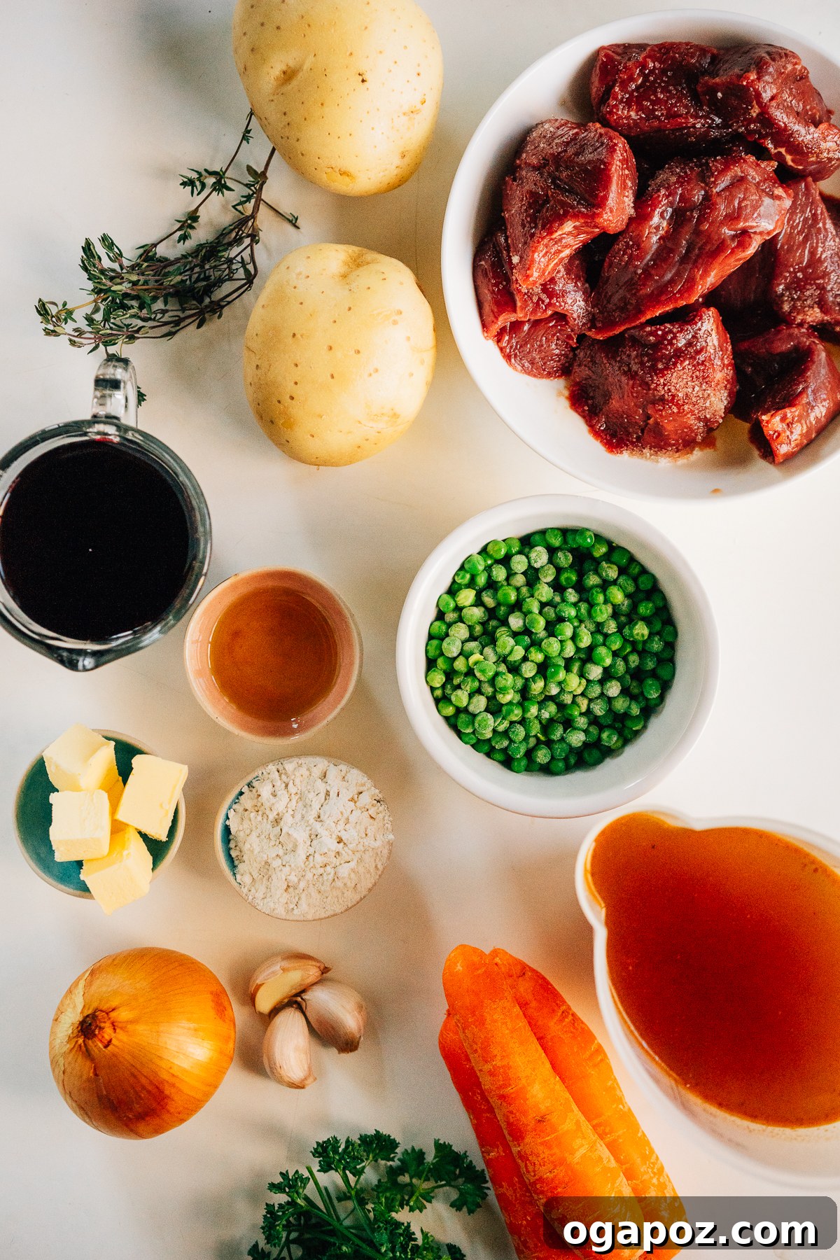 Hearty Dutch Oven Beef Feast 3 A collection of fresh ingredients laid out, ready for making Dutch Oven Beef Stew, including beef cubes, vegetables, and herbs.