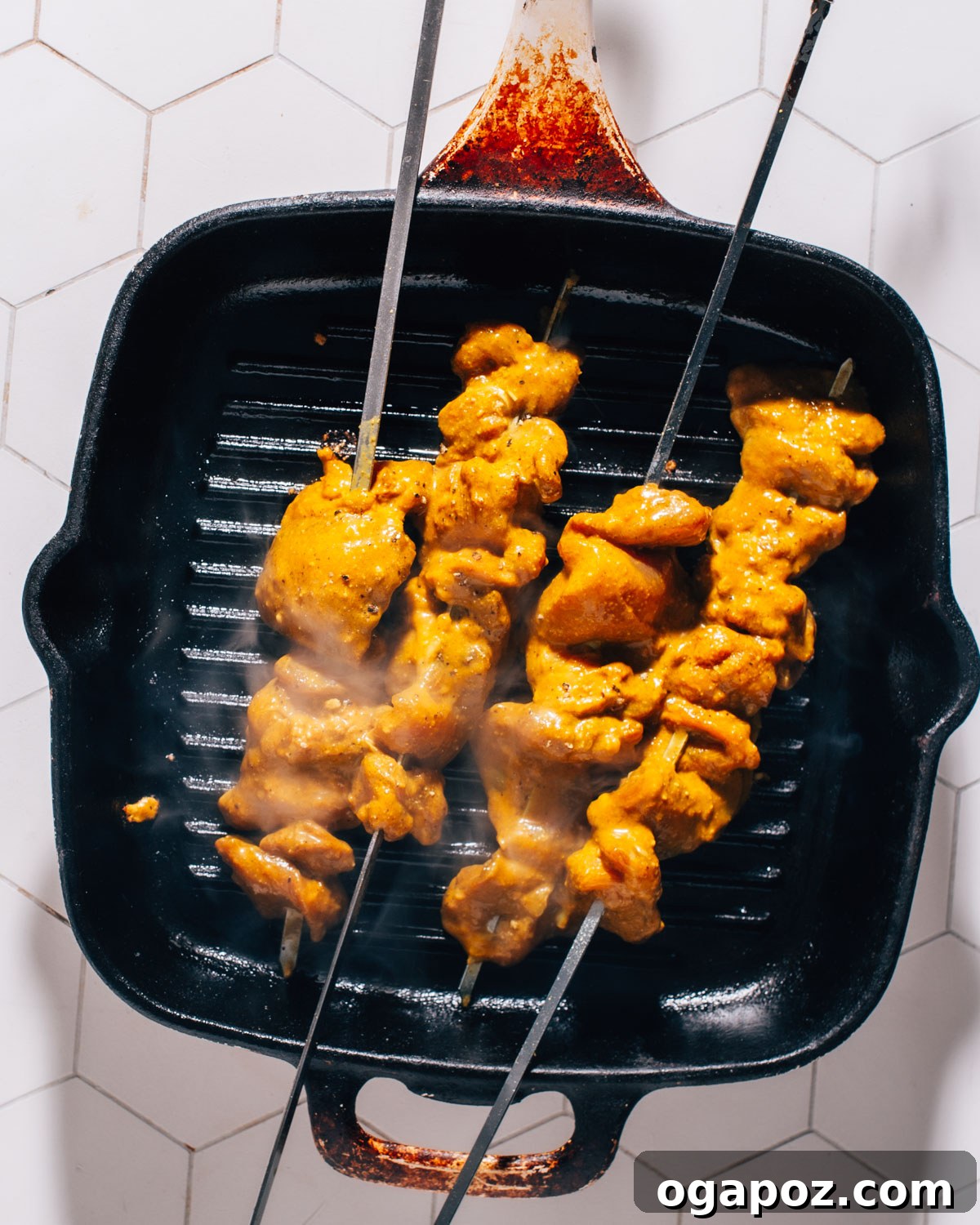 Irresistible Thai Satay Skewers 6 Thai Chicken Satay skewers grilling on an outdoor barbecue, developing a slight char.
