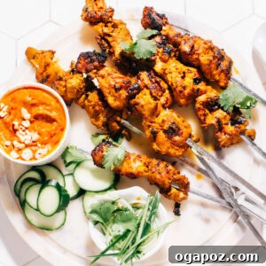 Irresistible Thai Satay Skewers 8 Thai Satay skewers with peanut sauce on a plate, ready to be enjoyed.