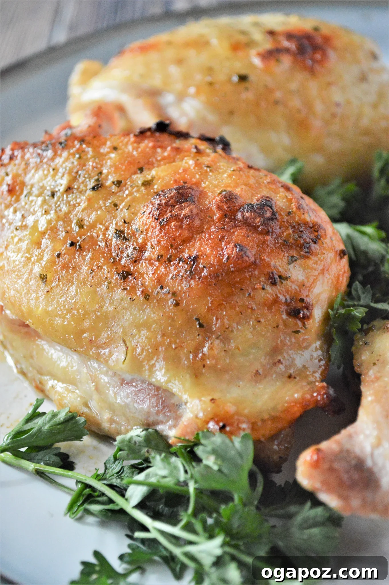 Creamy Ranch Chicken Thighs 4 Oven Baked Ranch Chicken Thighs served hot on a plate with a side of fresh green salad.