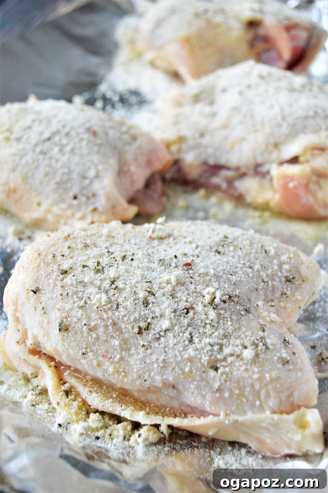 Creamy Ranch Chicken Thighs 6 Chicken thighs seasoned thoroughly with dry ranch mix, salt, and black pepper in a baking dish, ready to bake.