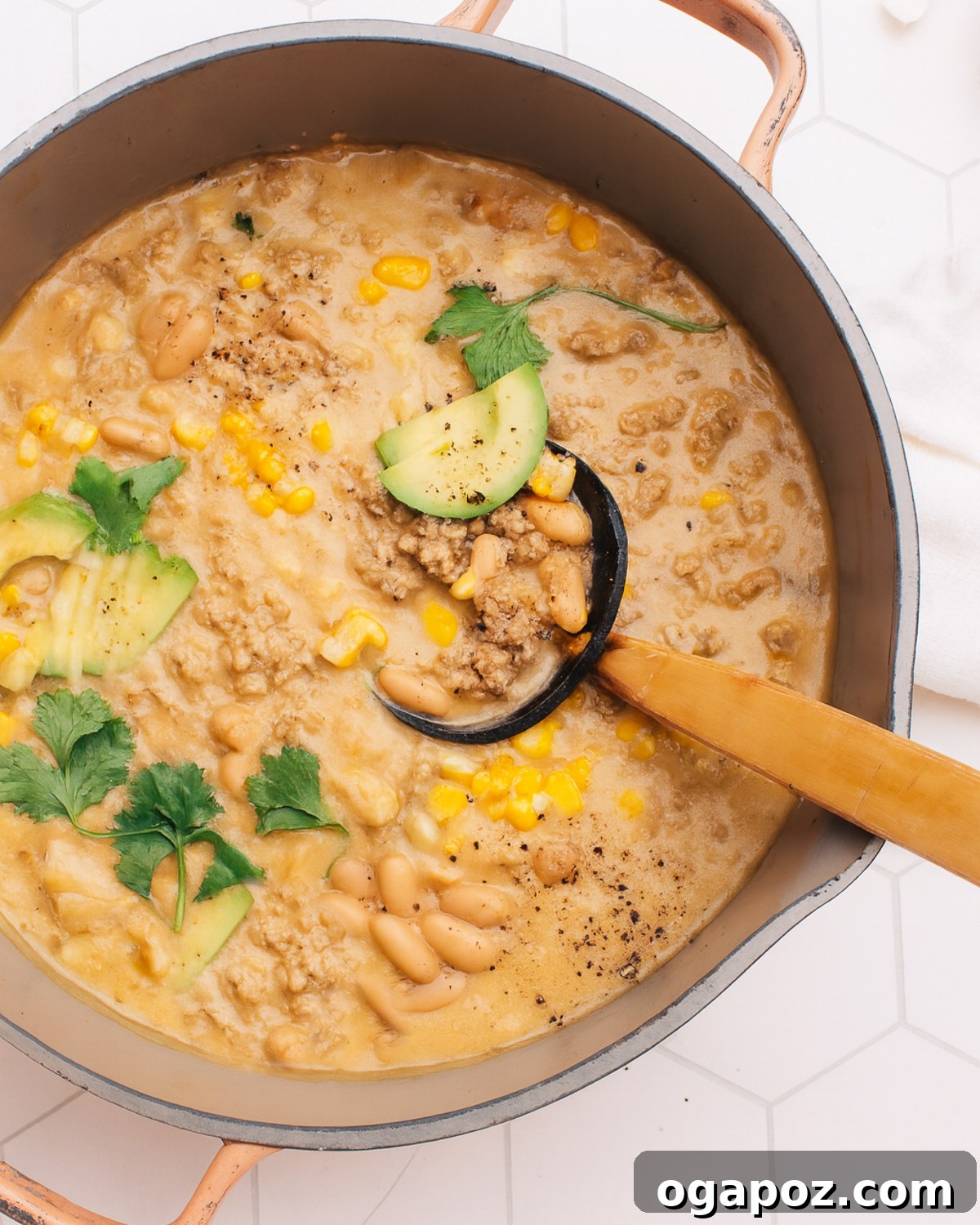 Wholesome Turkey and White Bean Chili 5 Creamy White Bean Turkey Chili simmering in a large pot, showing its rich, thick texture.