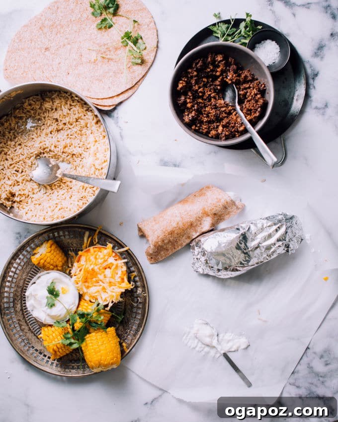 Easy Ground Beef, Rice, and Cheese Freezer Burritos 5 Fresh ingredients for homemade burritos, including herbs, cheese, and vegetables, arranged on a rustic cutting board.