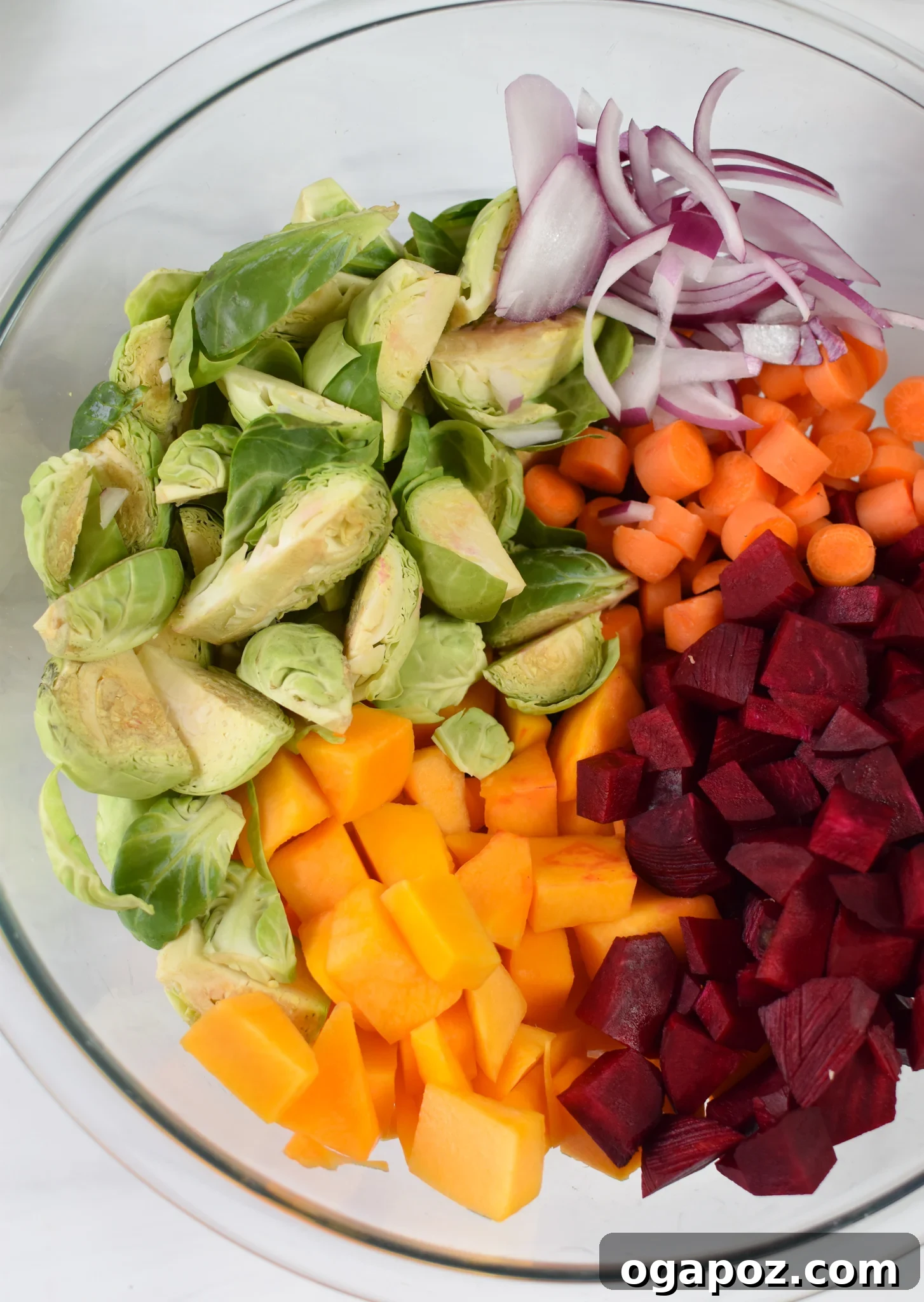 Golden Harvest Salad 6 Raw, seasoned Fall Harvest Salad vegetables in a mixing bowl, ready for roasting.